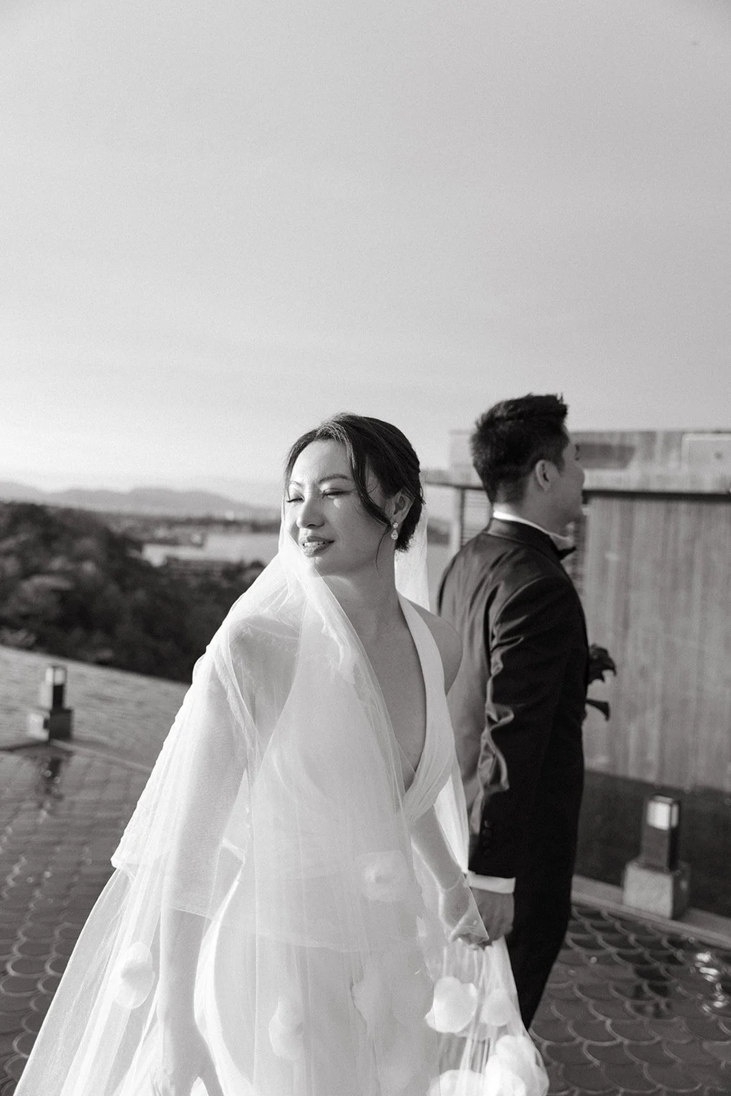 Candid photo of bride laughing with groom after modern seaside wedding ceremony in Thailand