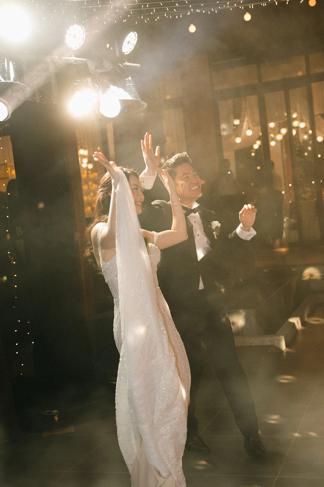 bride and groom celebrating at wedding reception