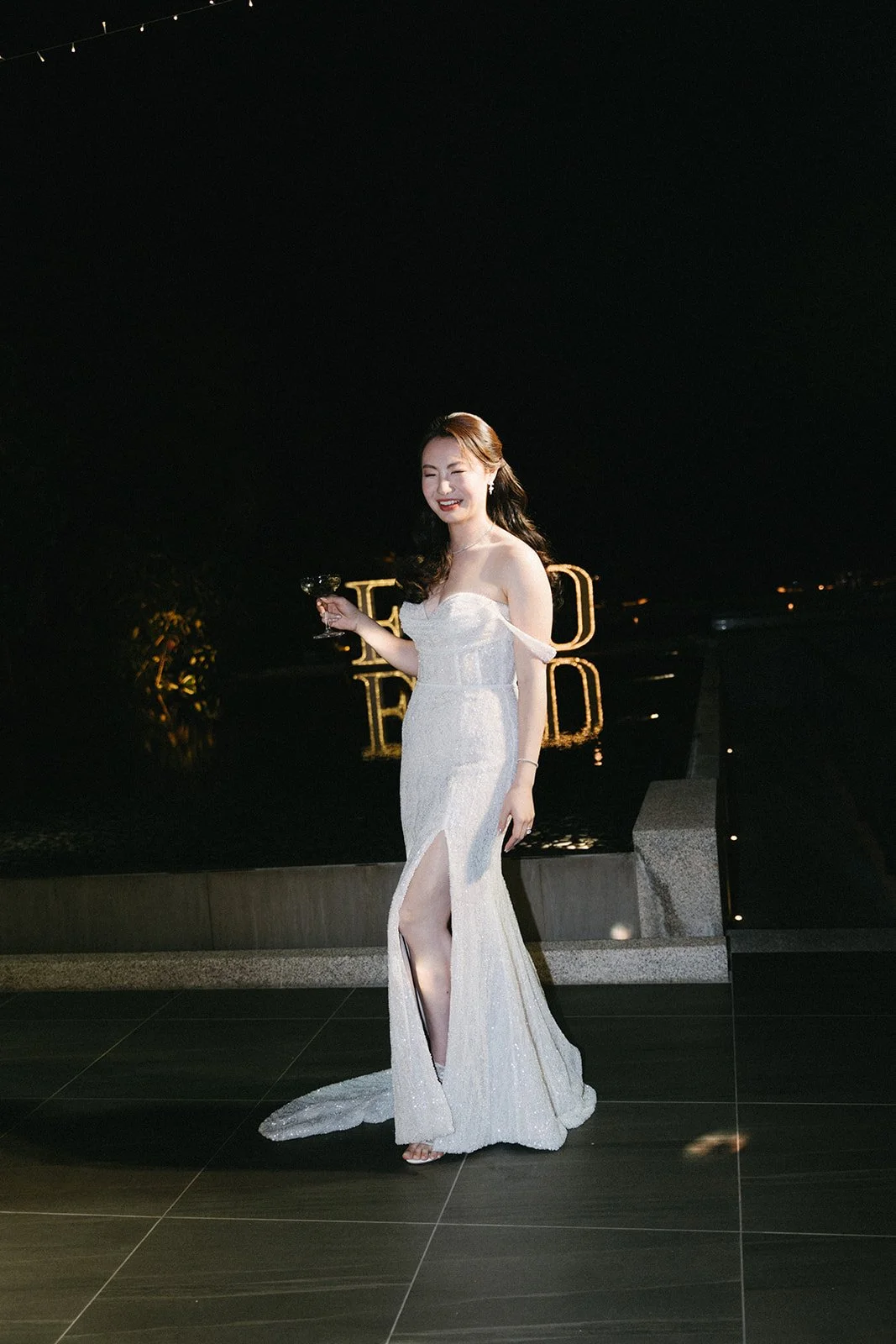 bride posing with a cocktail at wedding reception