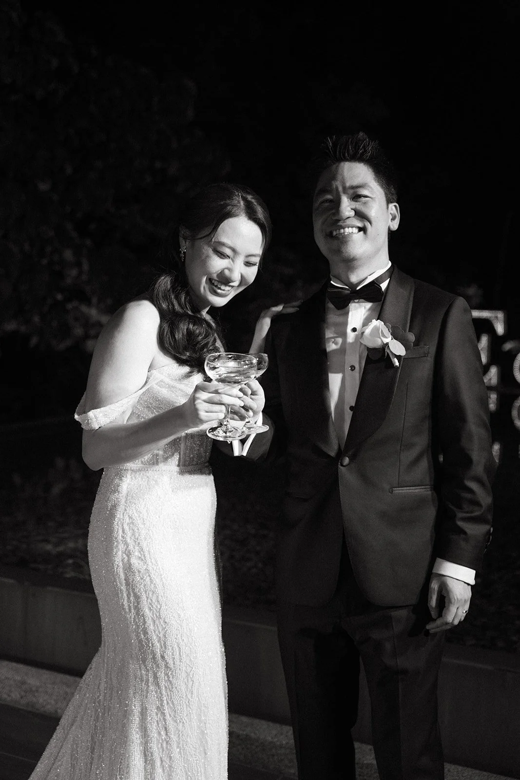 bride and groom holding cocktails