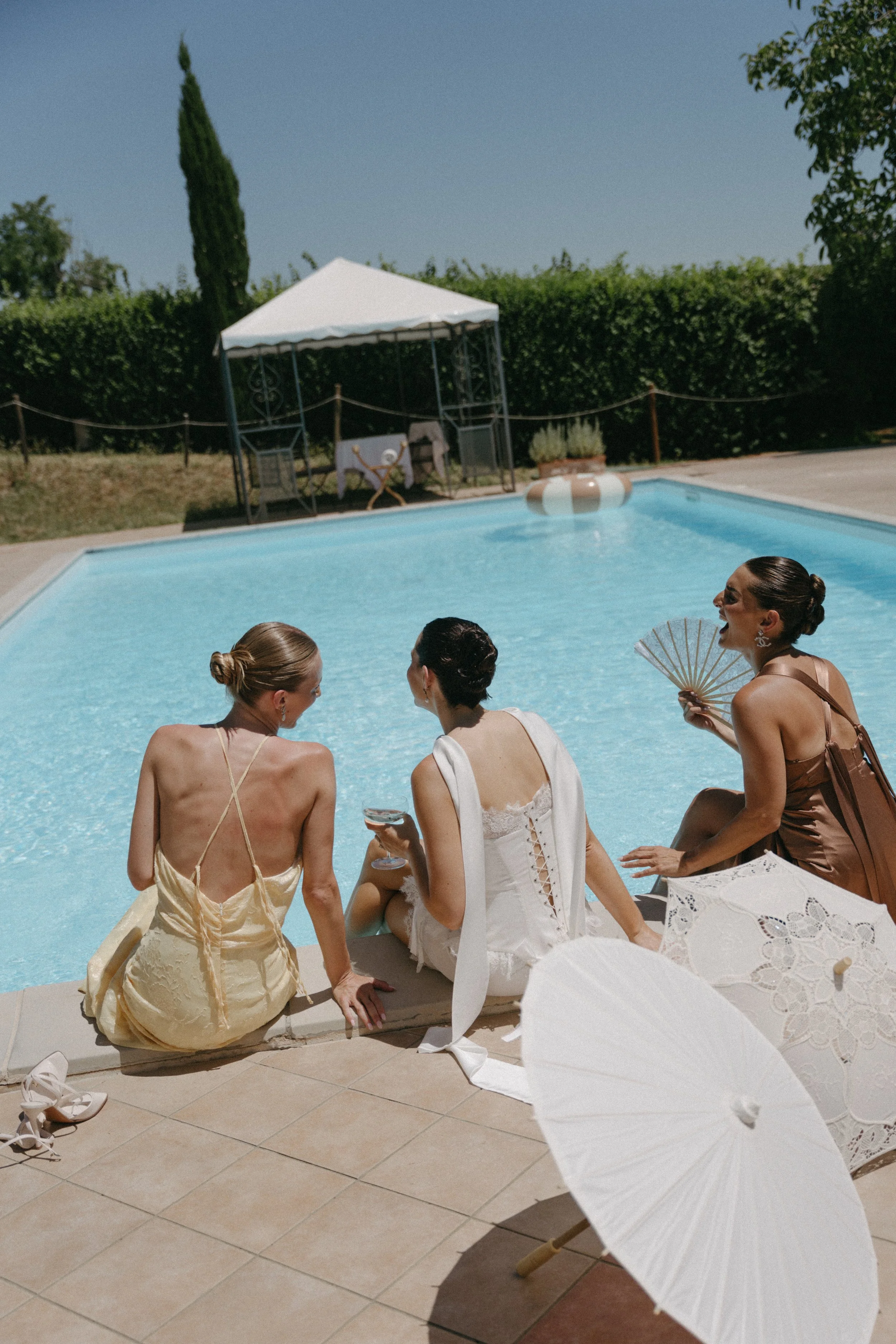 bridal party relaxing next to the pool at Villa Cozzano wedding