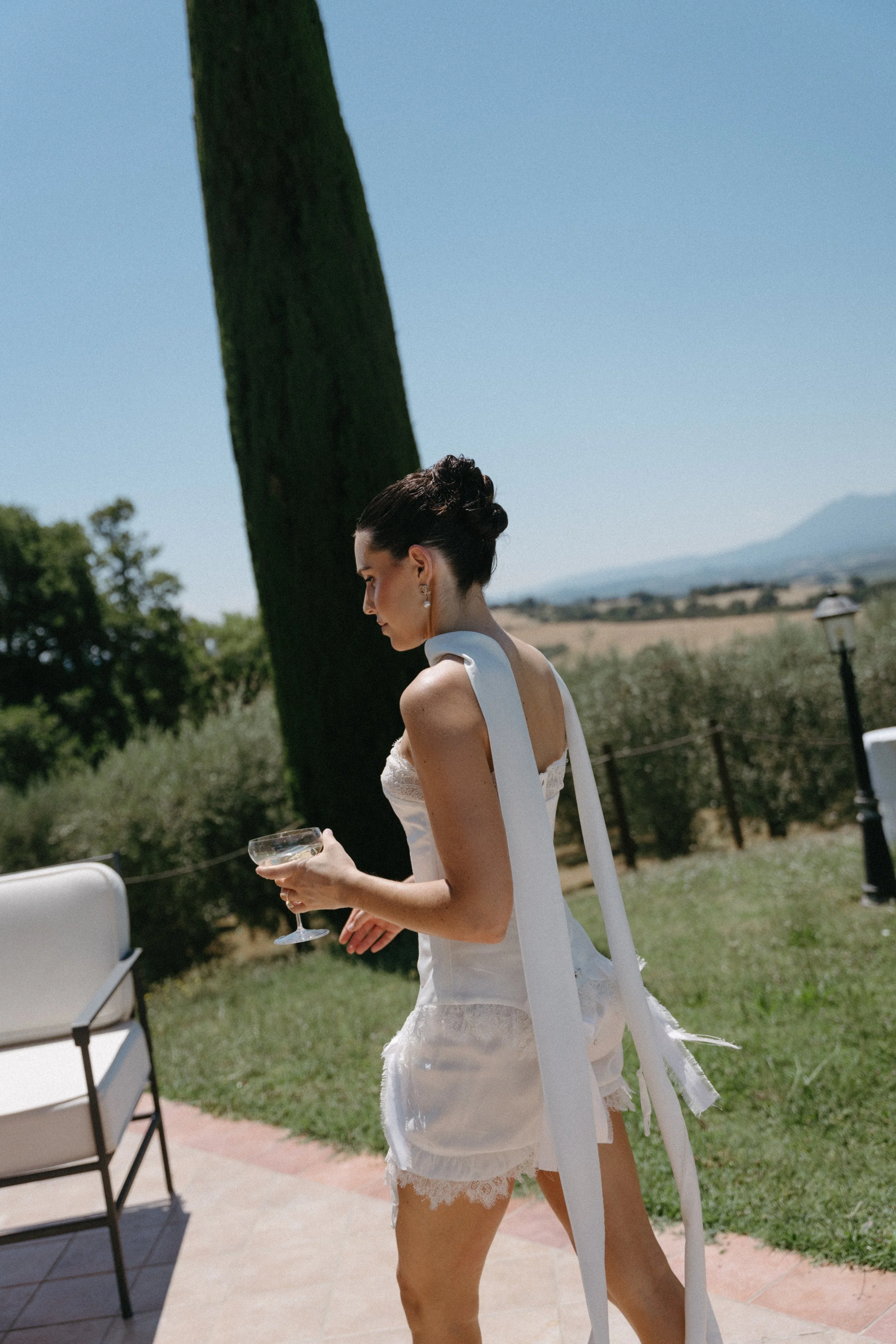 bride holding champagne glass during pre-wedding portrait