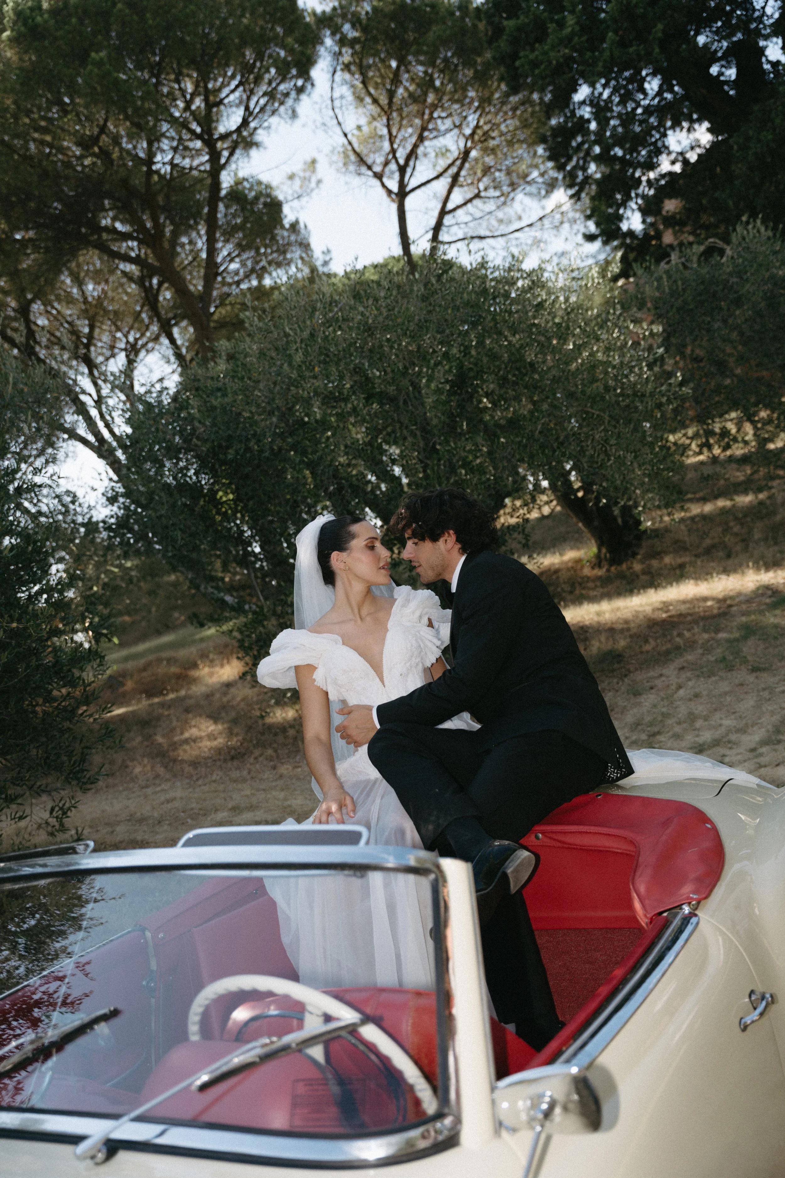 Groom in sleek black tuxedo with bride in couture gown at Villa Cozzano Tuscany