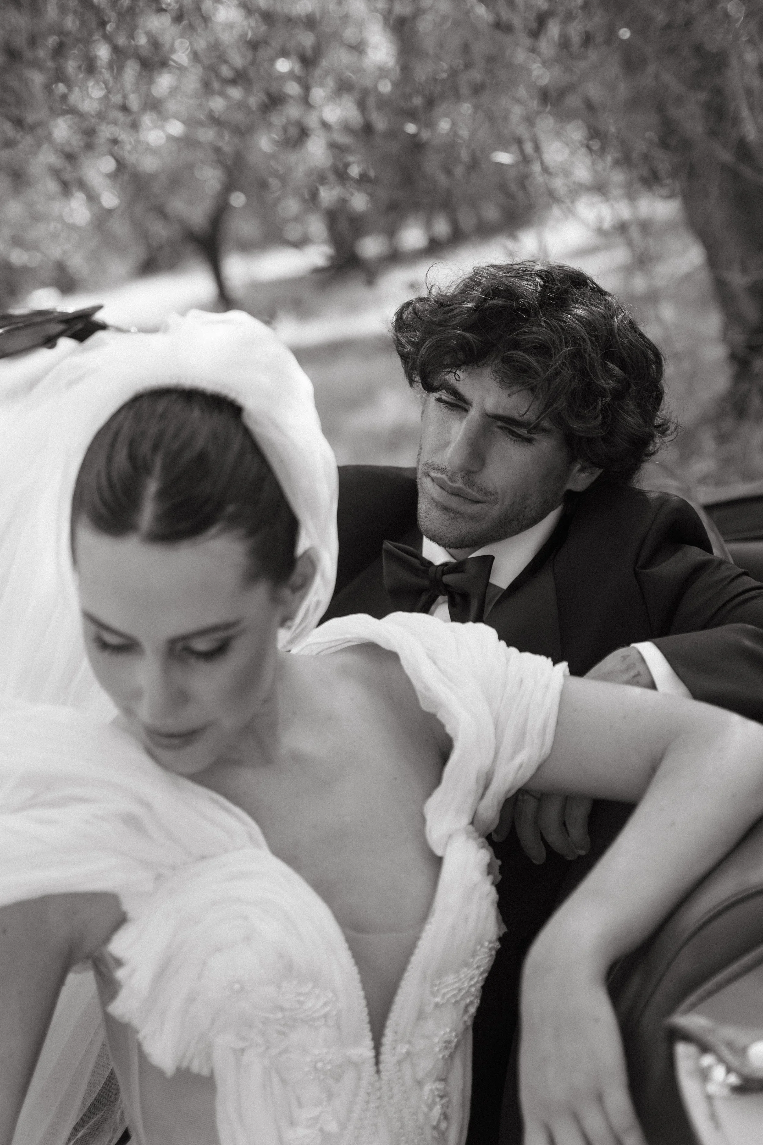 Groom in sleek black tuxedo with bride in couture gown at Villa Cozzano Tuscany