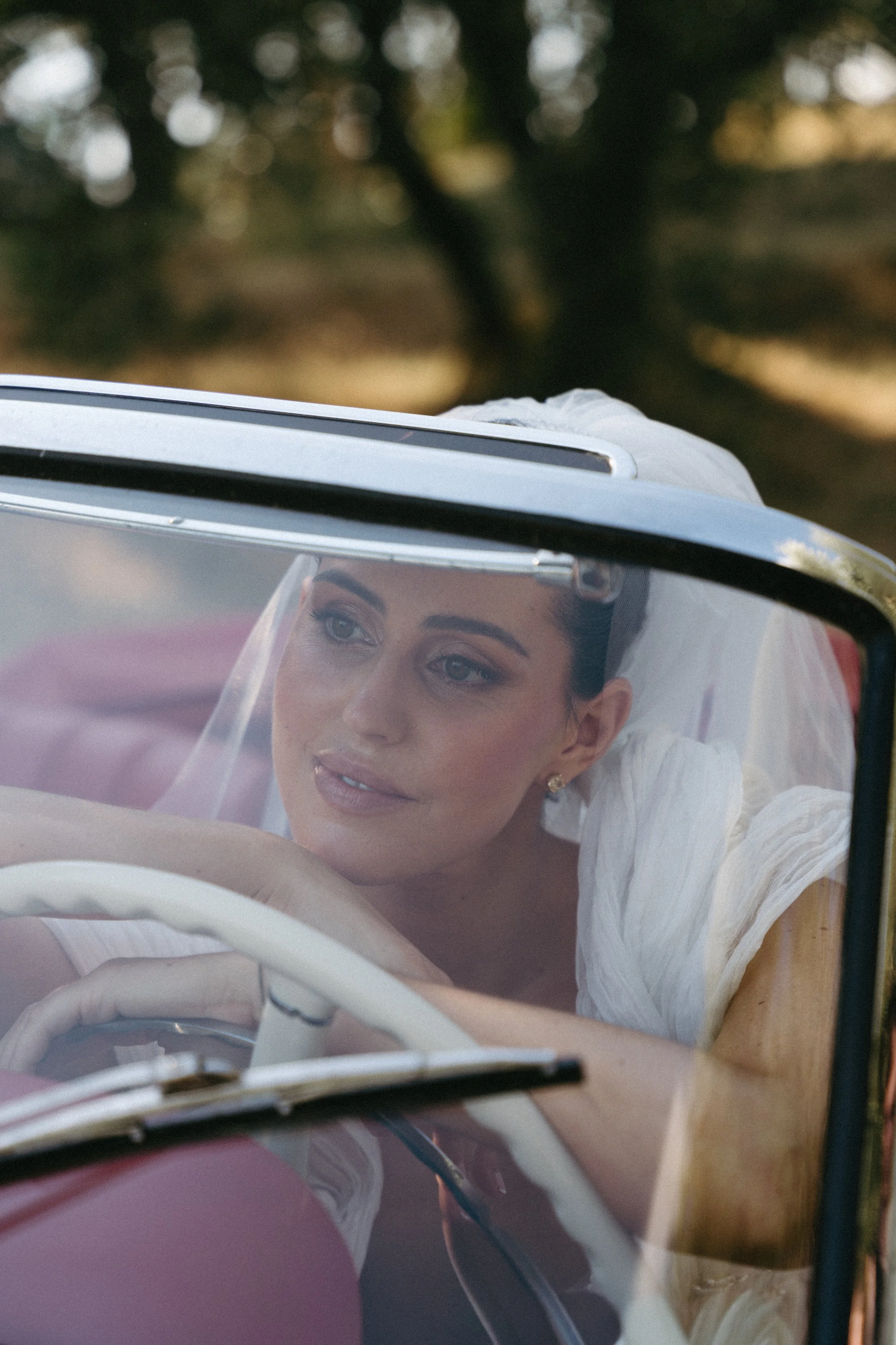bride sitting in car during villa cozzano tuscany wedding editorial shoot