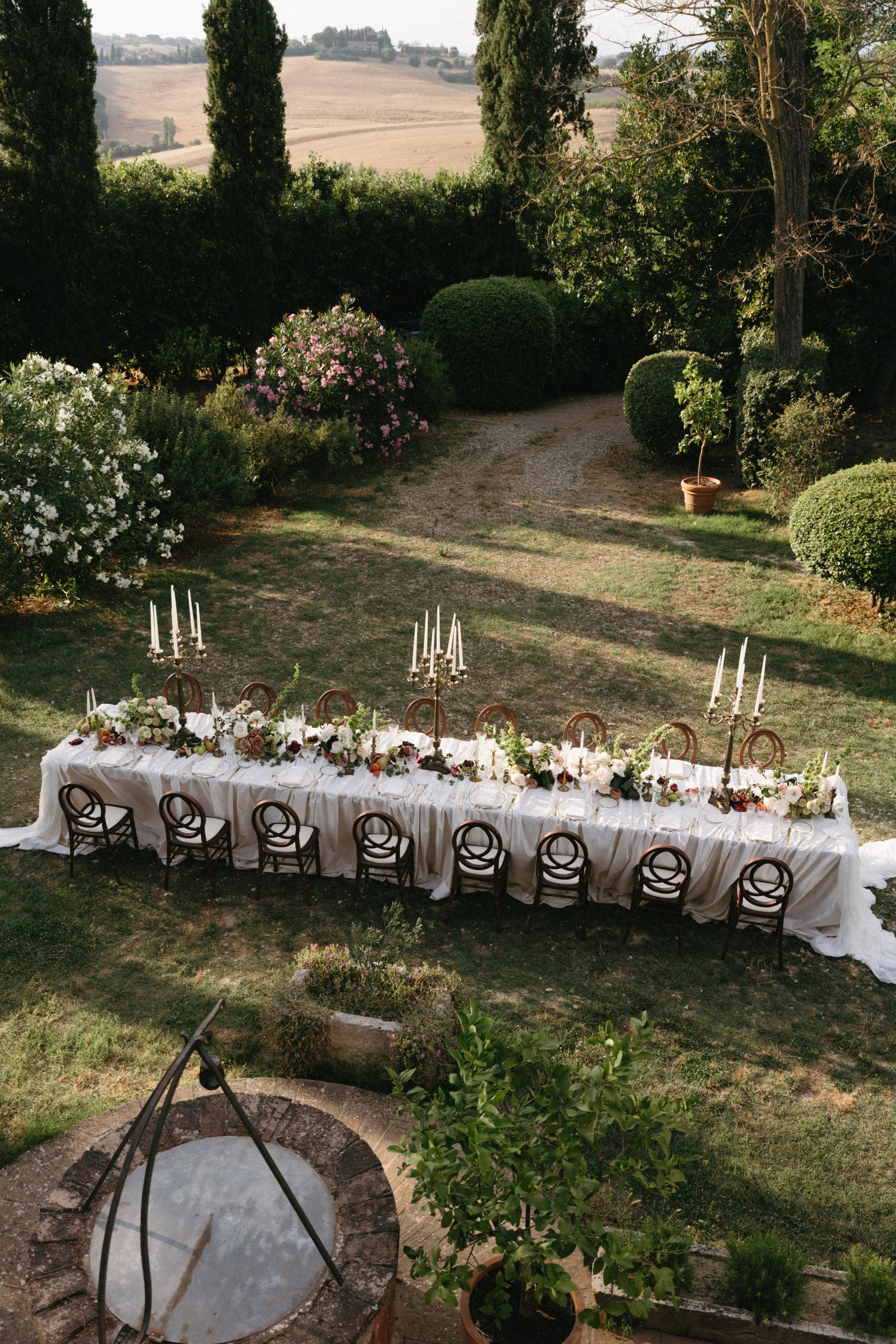 Intimate wedding reception details: floral centerpieces, candlelight, and elegant tableware