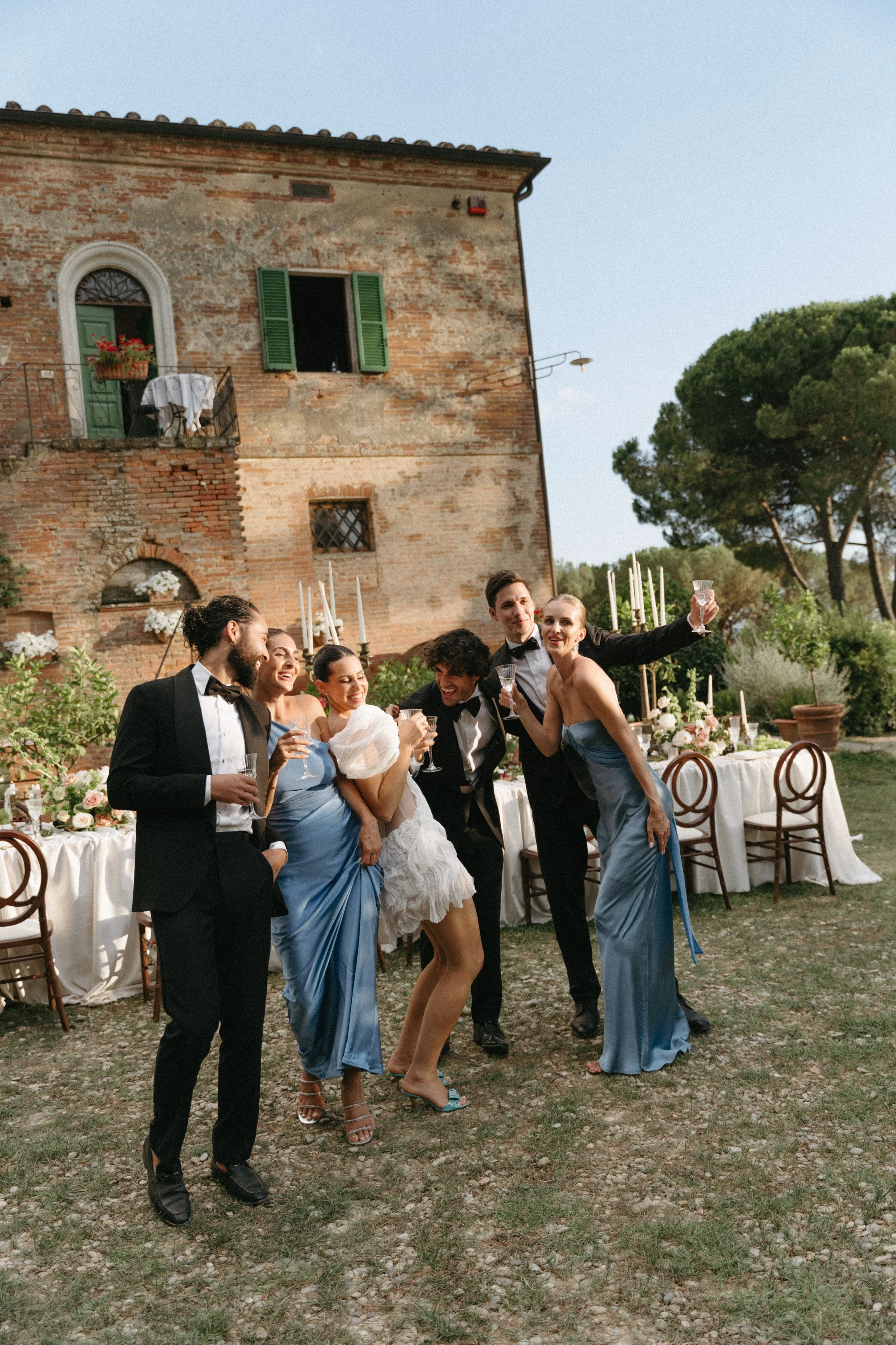 Wedding party enjoying playful moments outdoors at Tuscany micro wedding