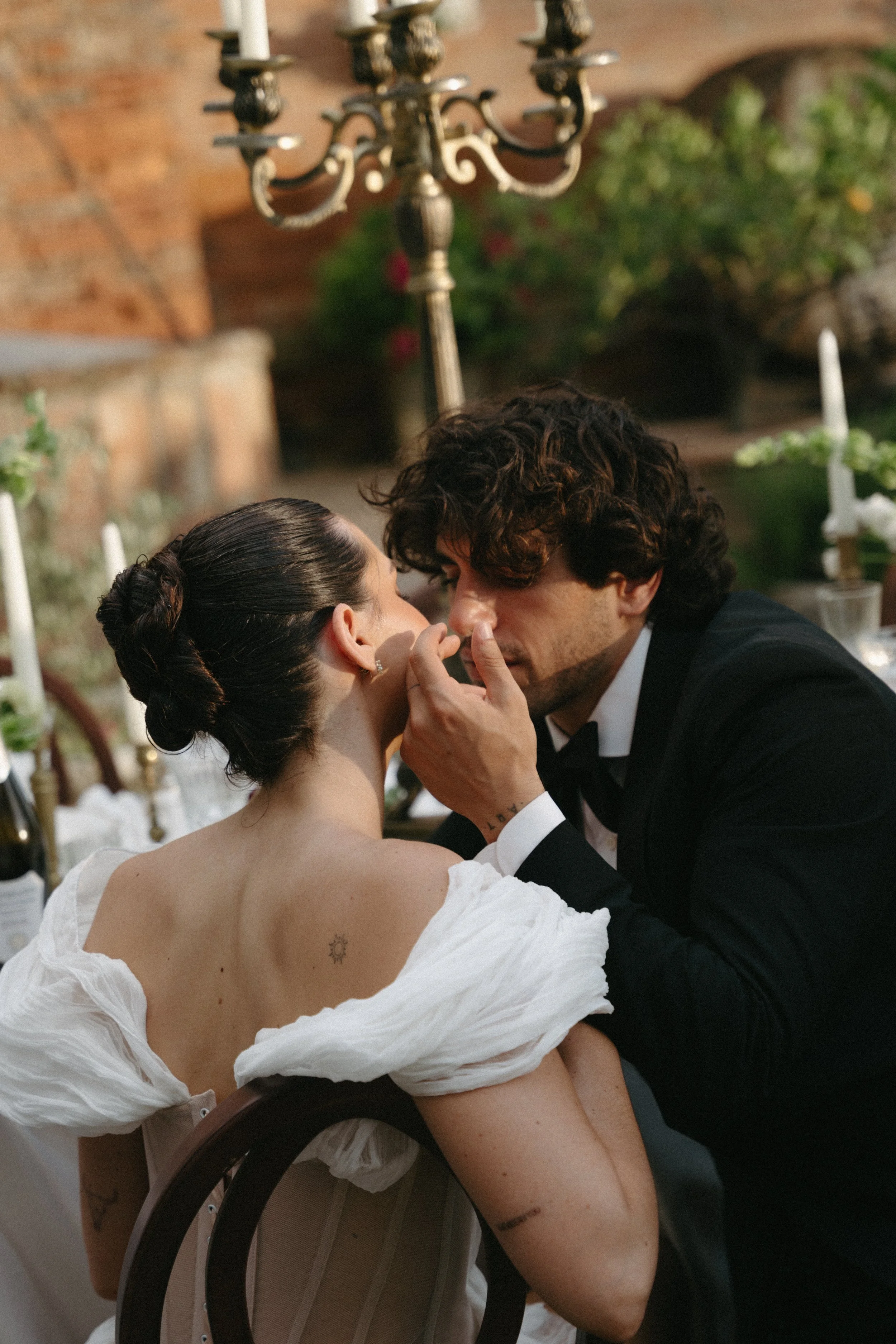 Groom gently touching bride’s face during editorial photoshoot at Villa Cozzano