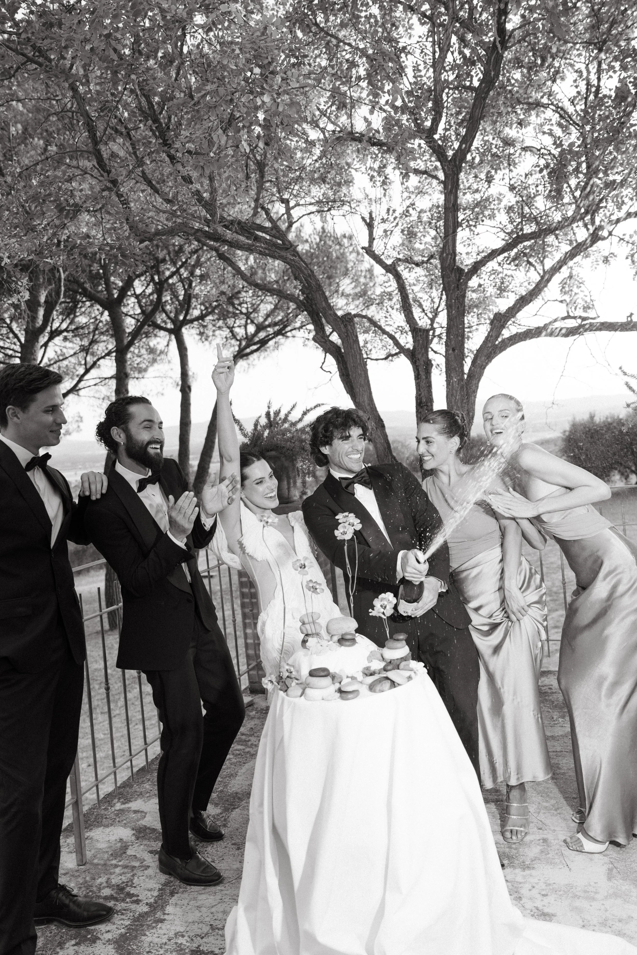Guests enjoying wedding cake designed as stone sculpture at Tuscany editorial shoot