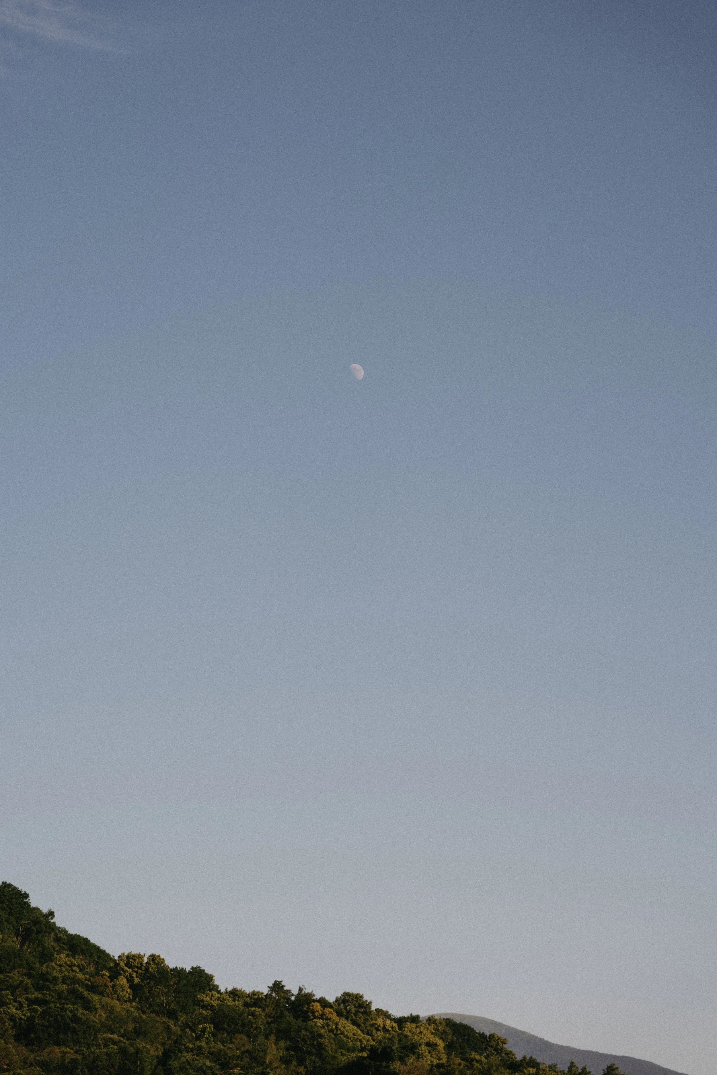 dreamy photo of the moon in the sky from a distance