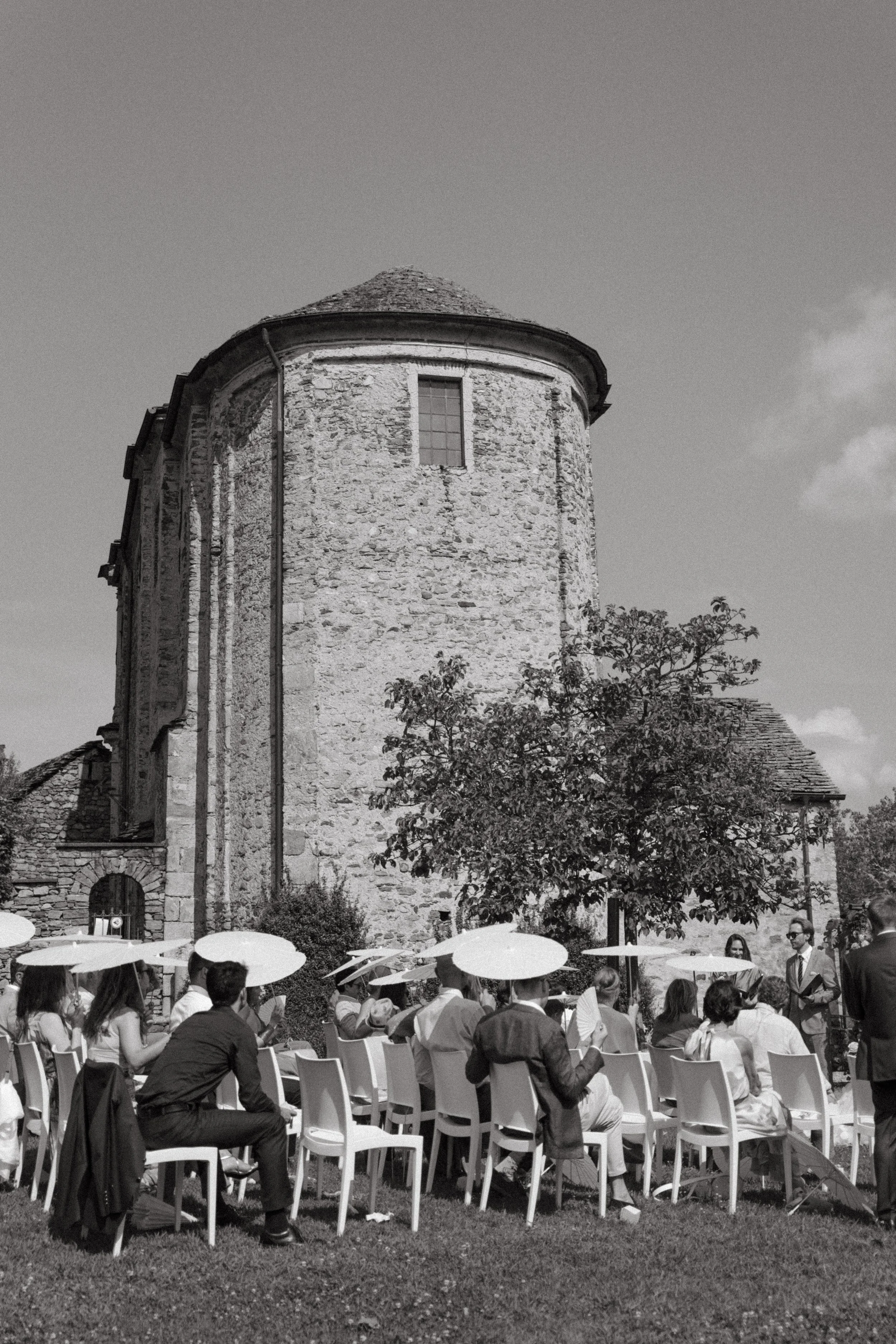 Wide shot of the ceremony framed by historic villa architecture and nature at Villa San Quirico, Minusio 