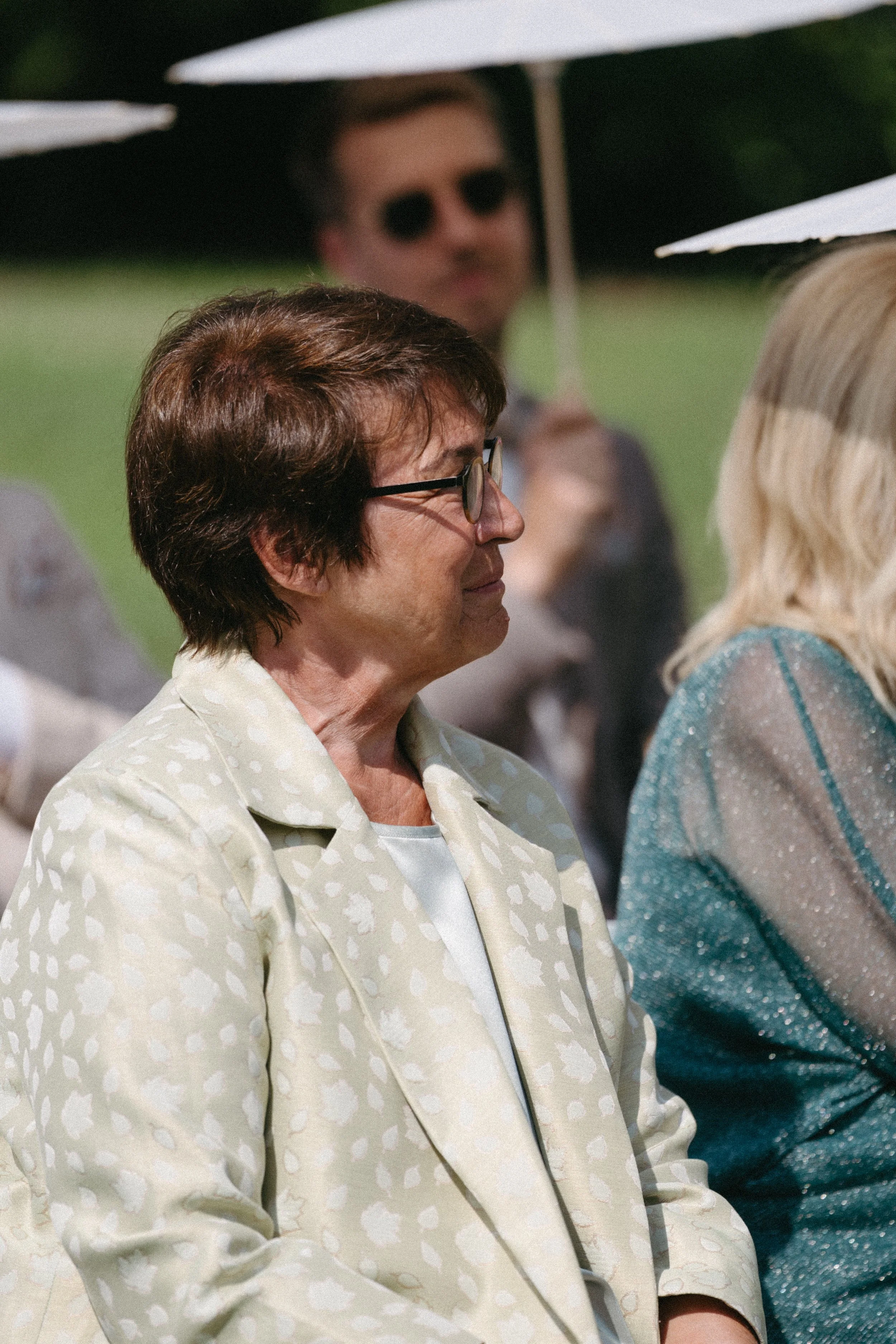 close up of wedding guest as bride walks down the aisle