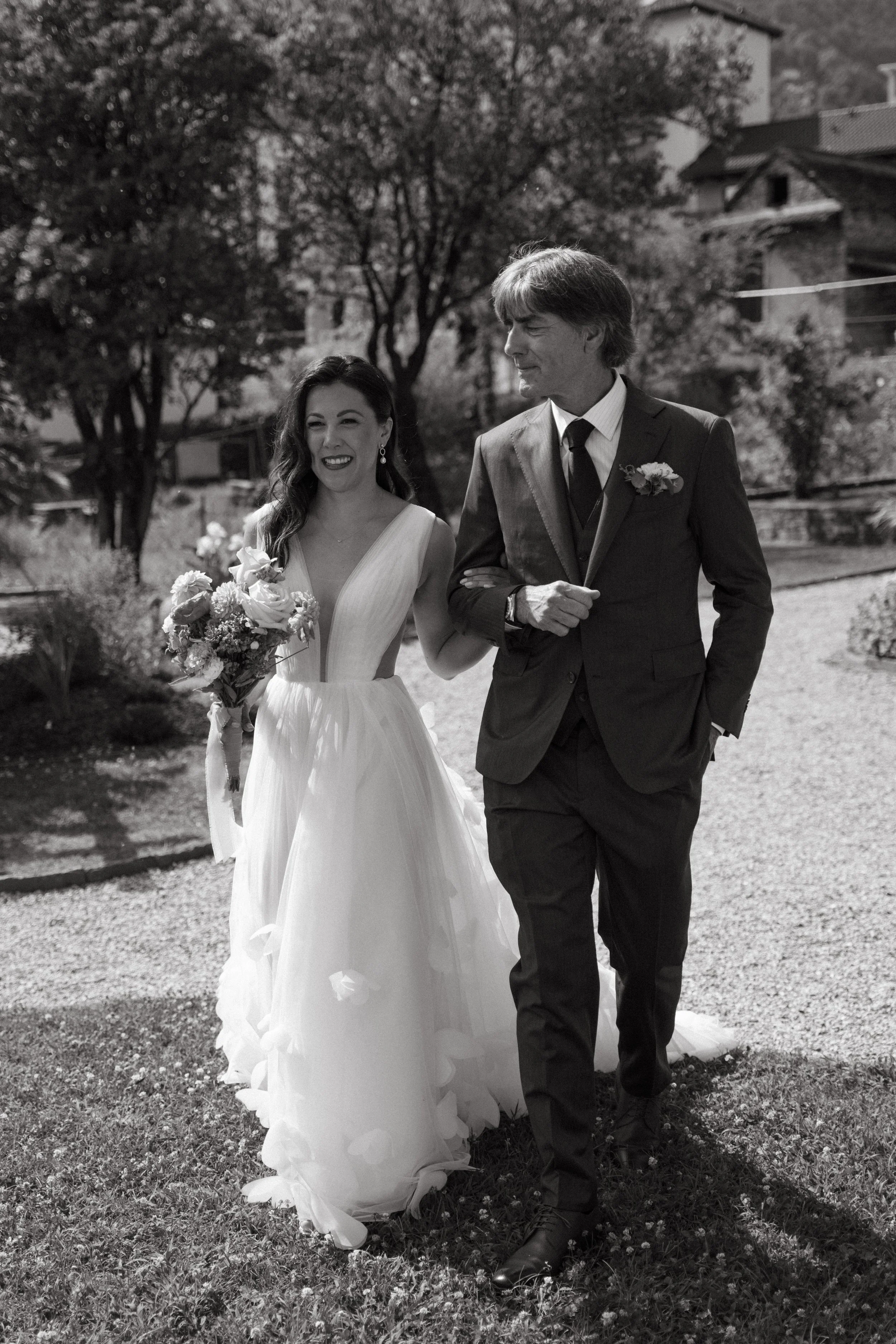 beaming Bride walking down the aisle at Villa San Quirico in Minusio