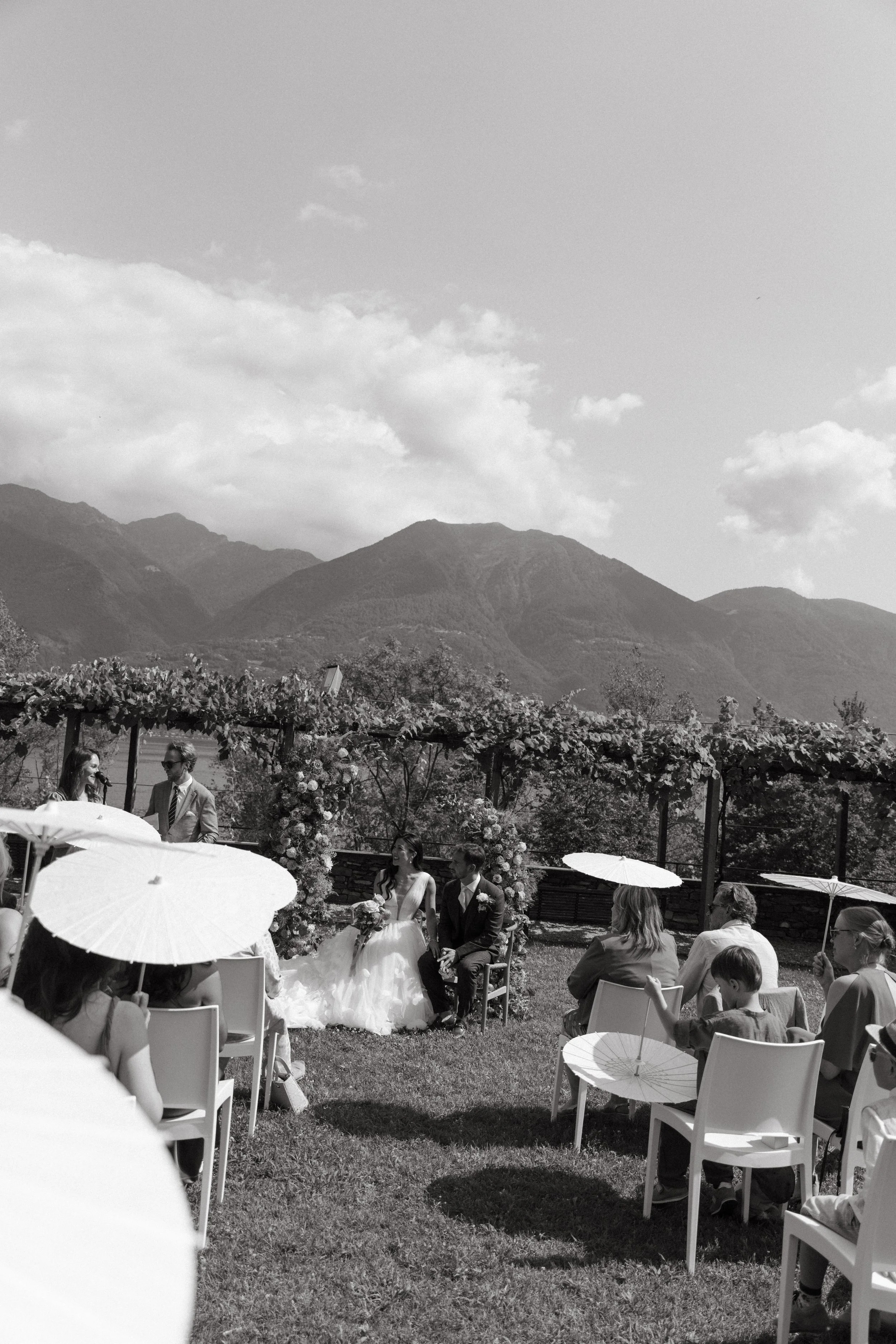 Wide shot of the ceremony framed by historic villa architecture and nature
