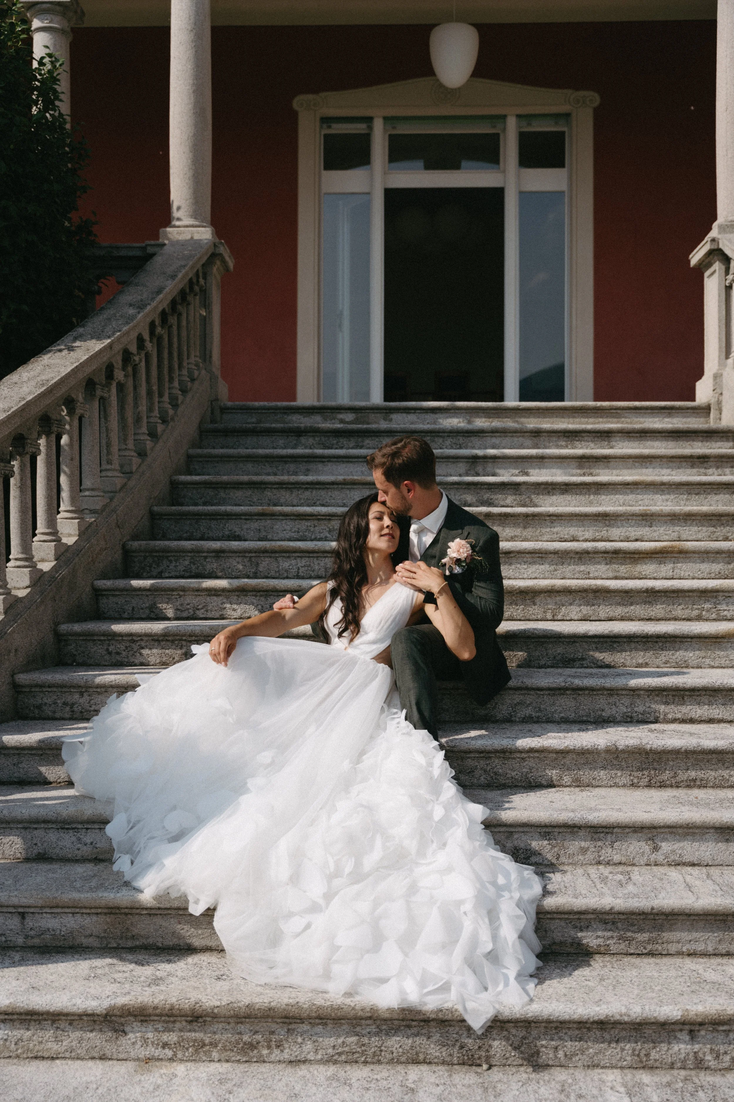 bride and groom sitting on the stairs at Villa San Quirico, Minusio