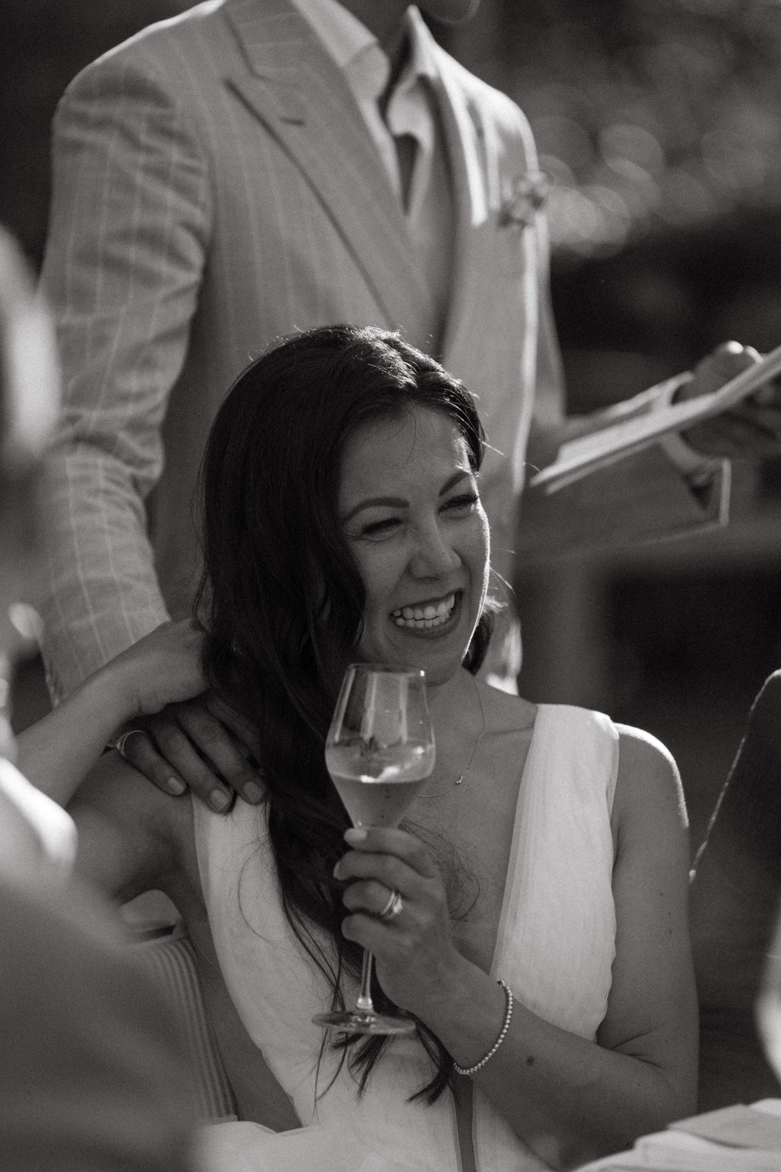 bride's candid reaction during wedding reception speeches at Hotel Giardino in Ascona, Switzerland