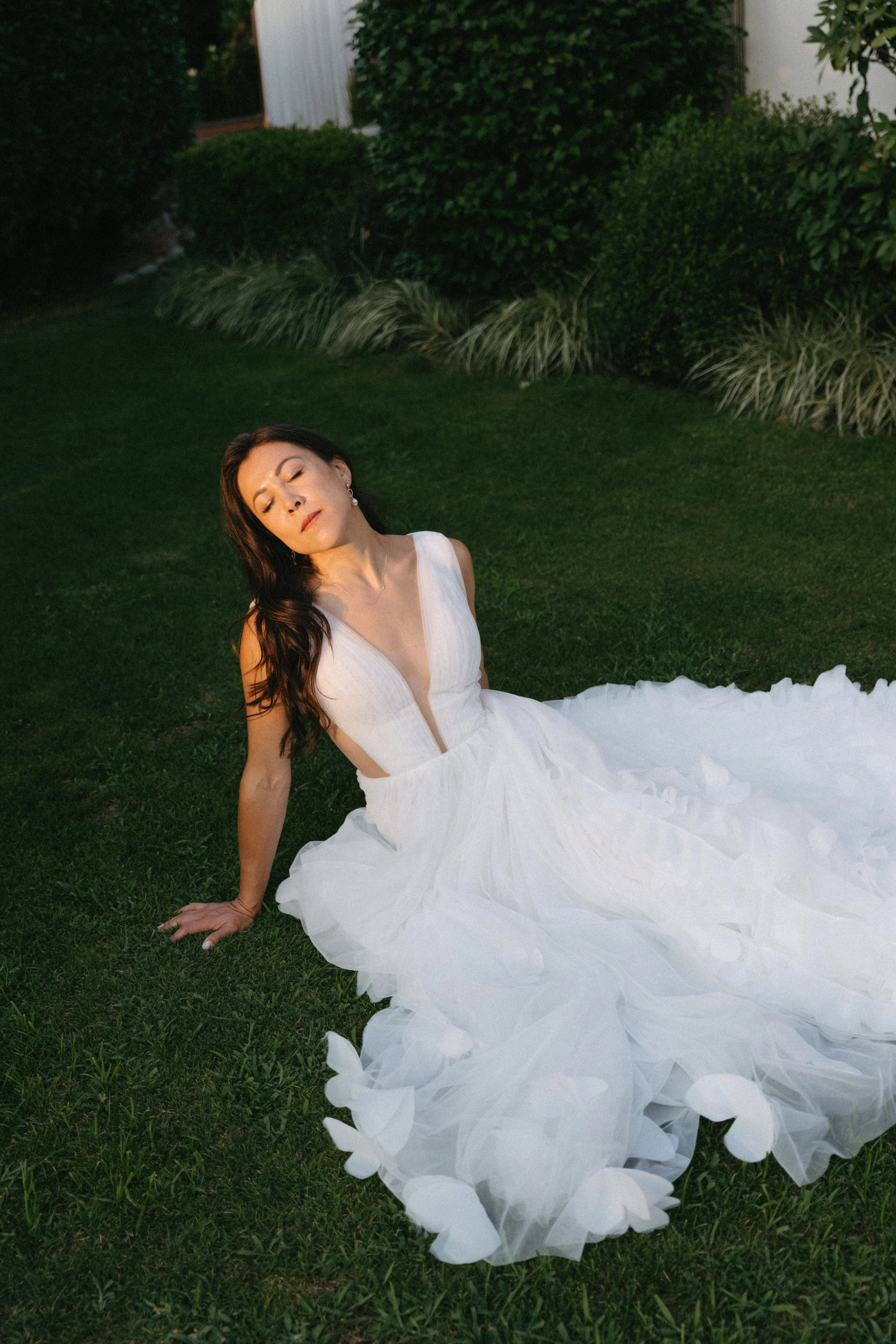 Elegant bridal portrait surrounded by lush greenery