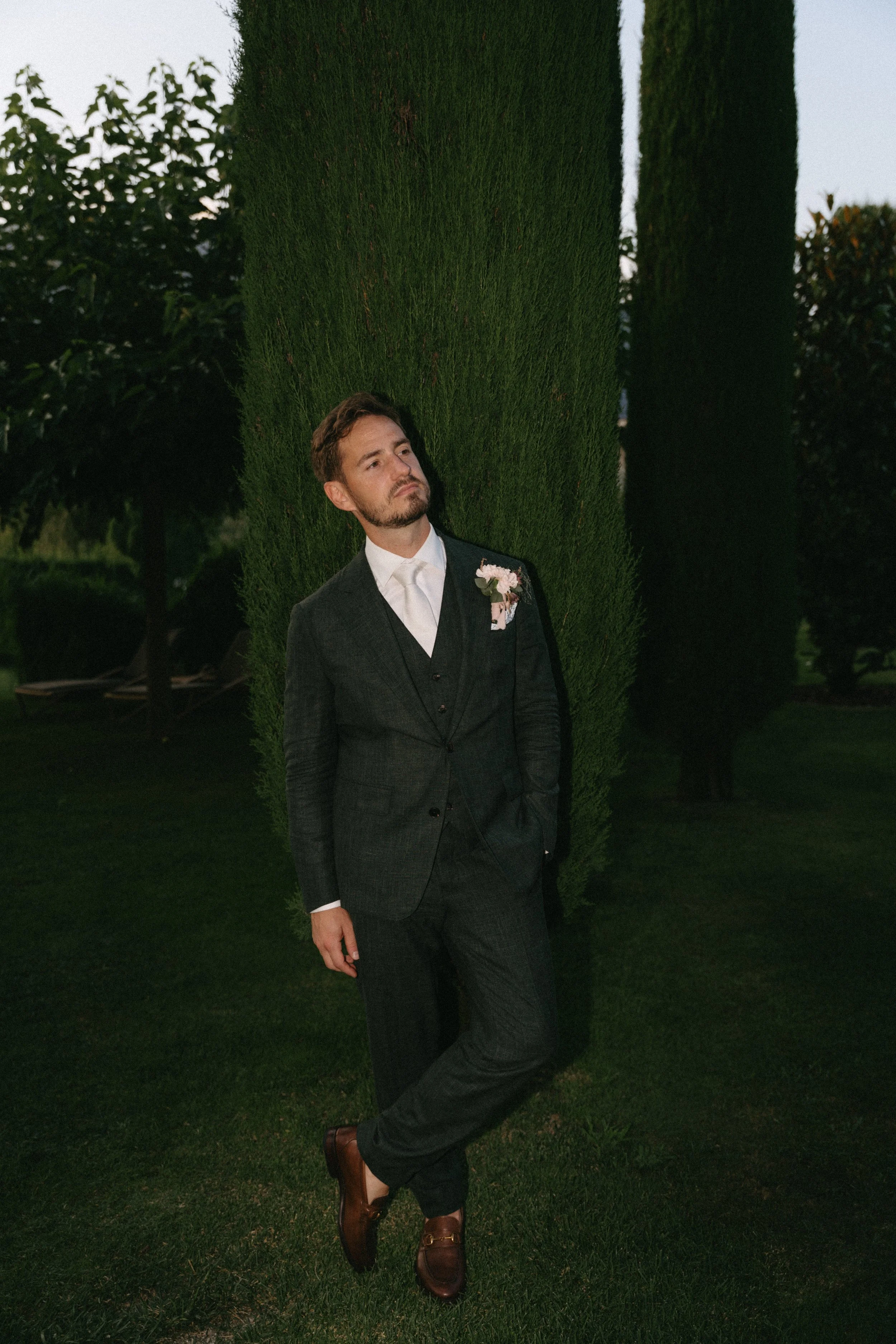 Relaxed portrait of the groom in a timeless black suit at Villa San Quirico