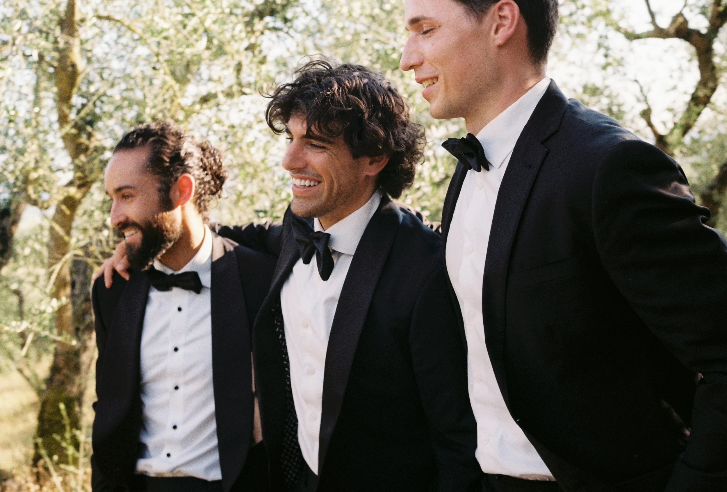 candid destination wedding photo of groom's party shot on film in italy