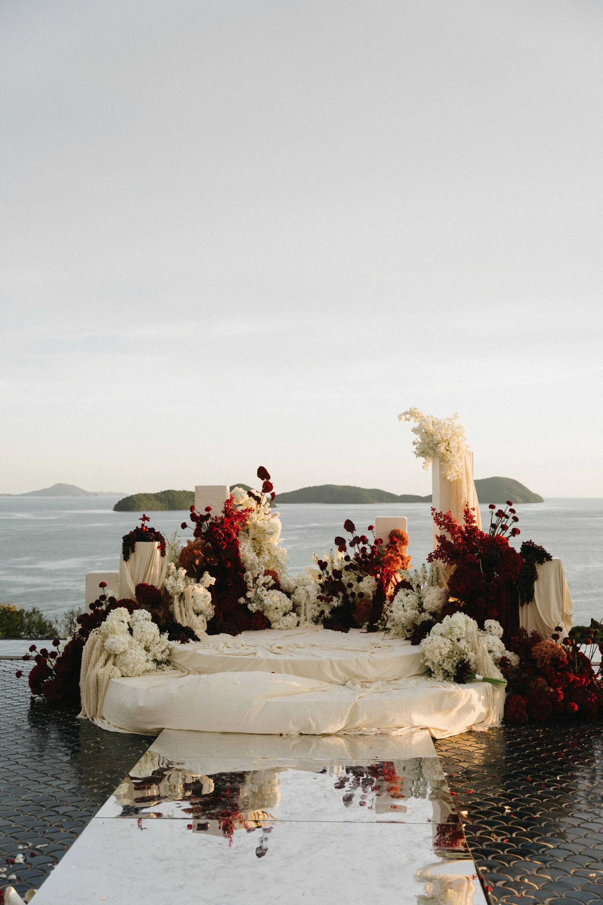luxury outdoor wedding ceremony setup on the water at sri panwa