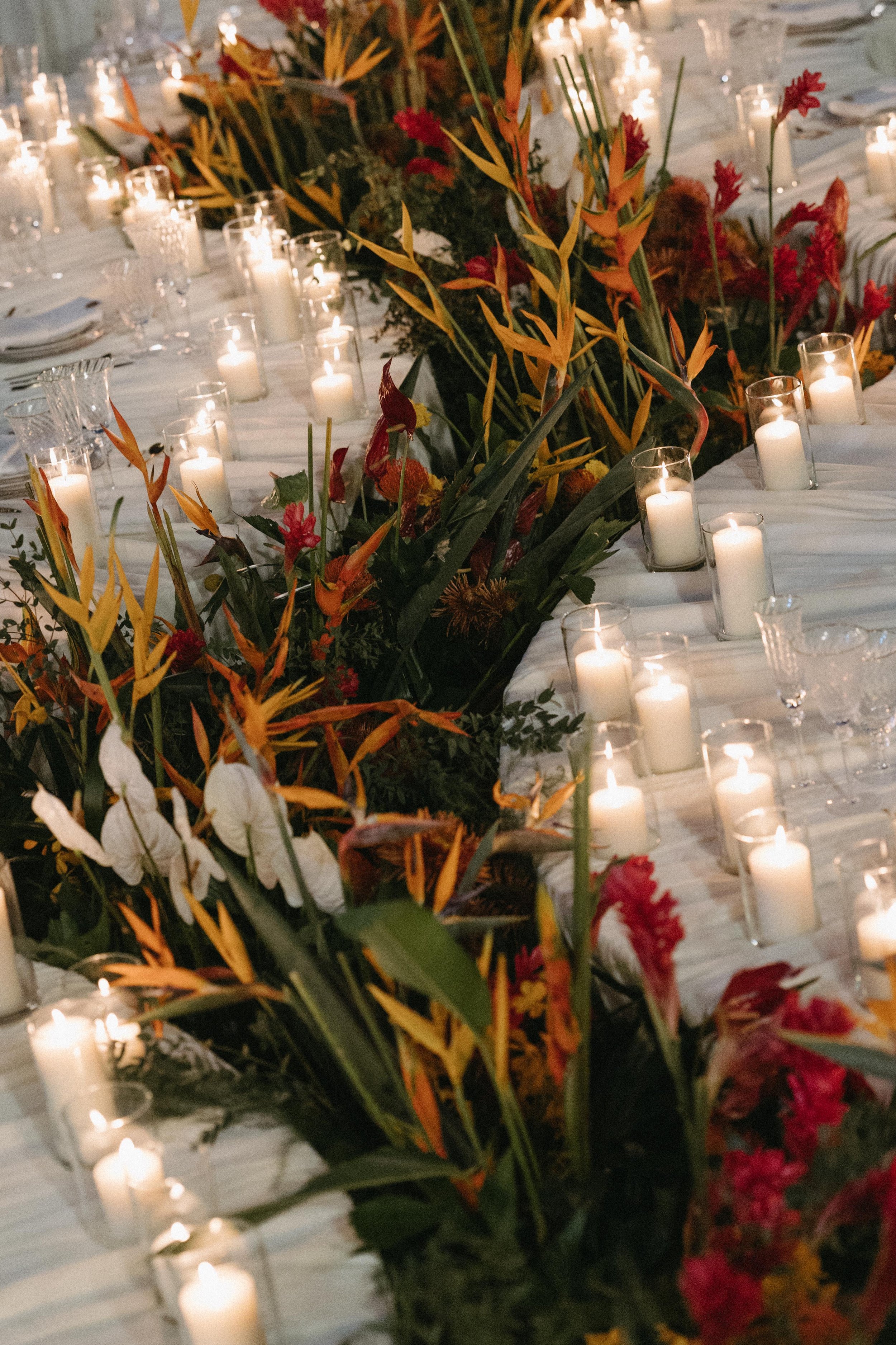 portrait of pillar candles and organic floral setup for reception at elite havens in phuket