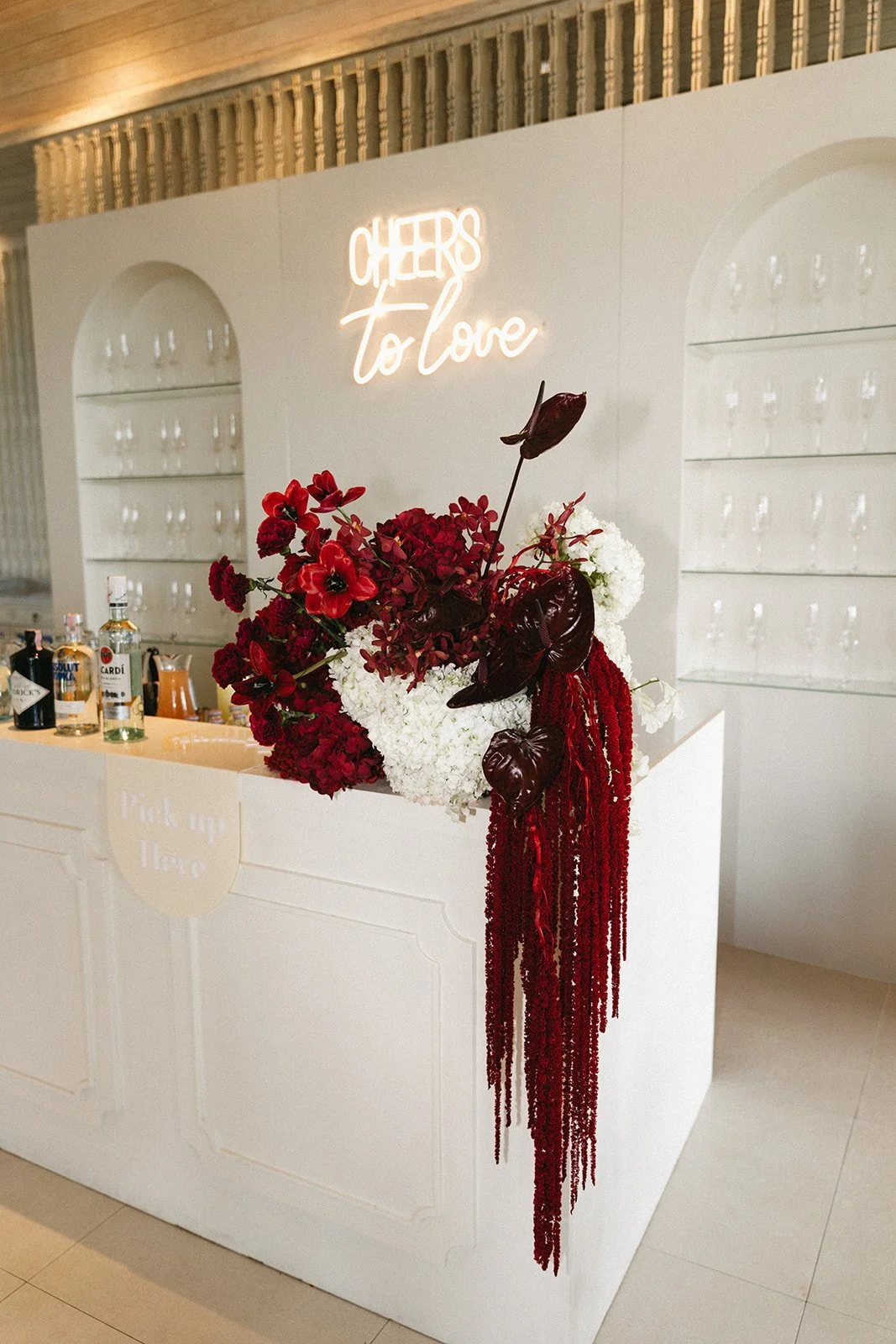 bar table setup with stunning crimson florals at sri panwa luxury wedding reception
