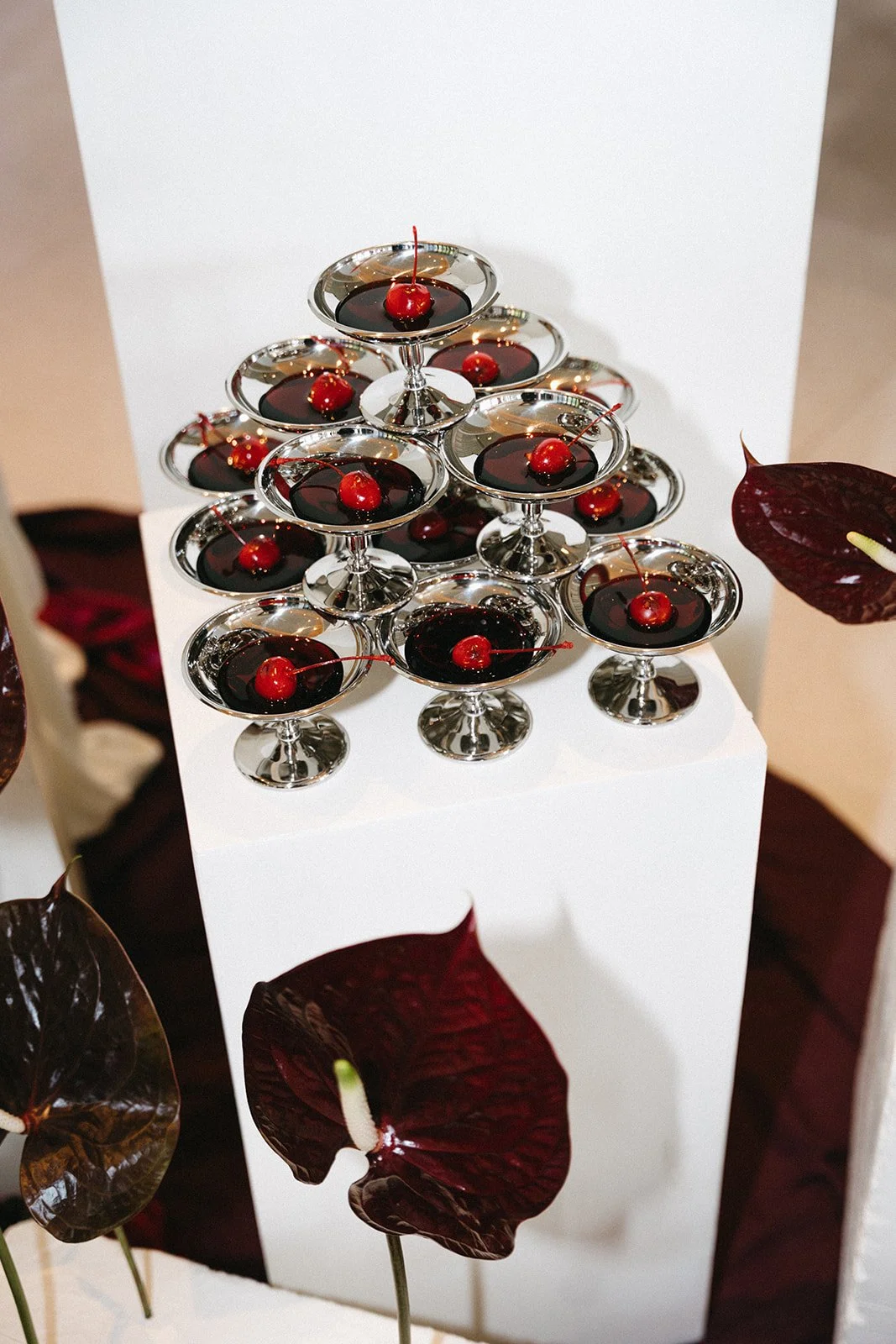 tower of silver flutes with cherry liquor for destination wedding reception at sri panwa