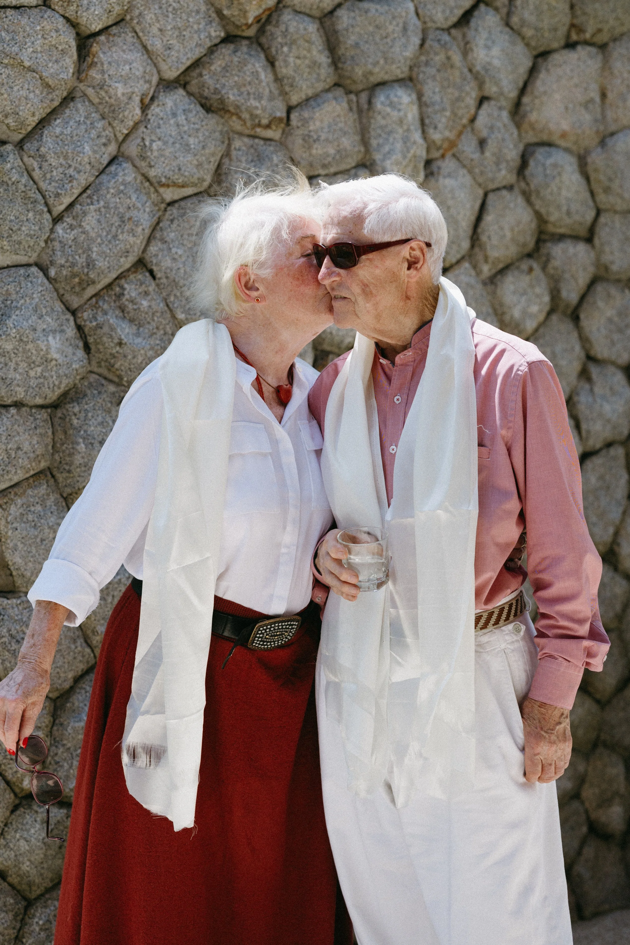 elderly guests leaning in for a kiss after Sikkimese Buddhist ceremony