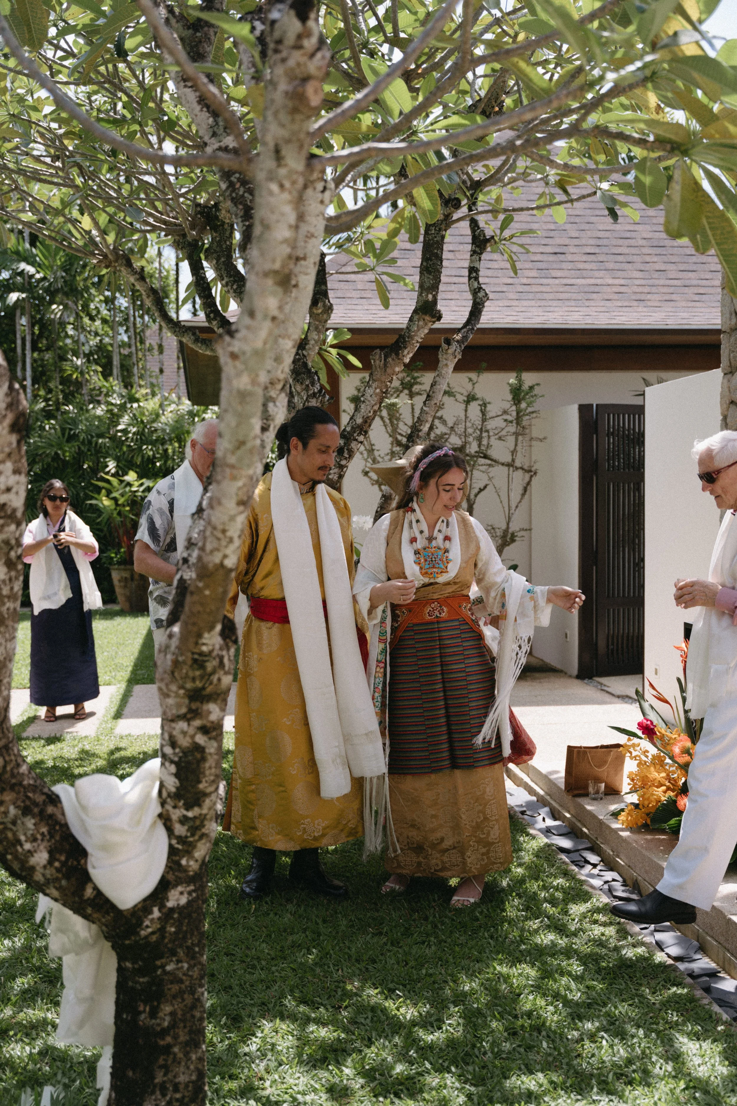 couple wearing traditional attire during Sikkimese Buddhist ceremony at jivana beach villas