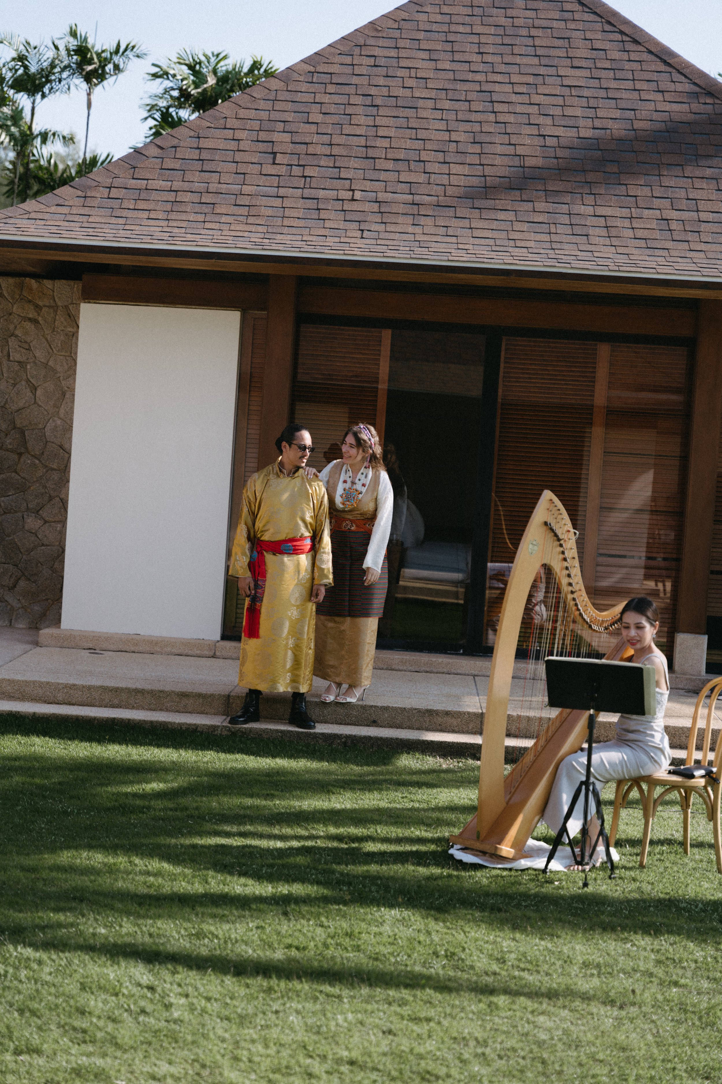 couple wearing traditional attire relaxing after Sikkimese Buddhist ceremony