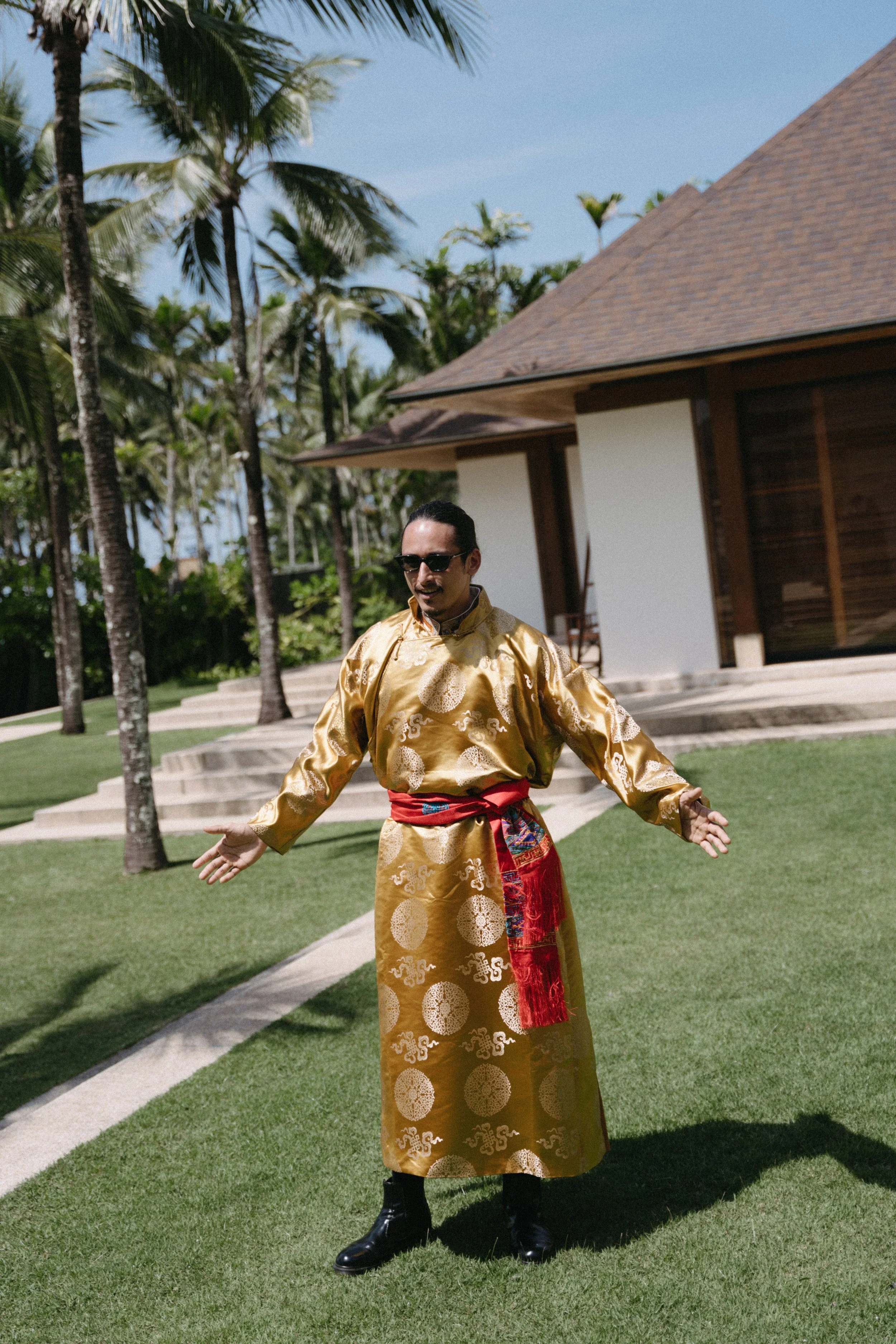 groom wearing traditional attire for Sikkimese Buddhist wedding ceremony at jivana beach villas