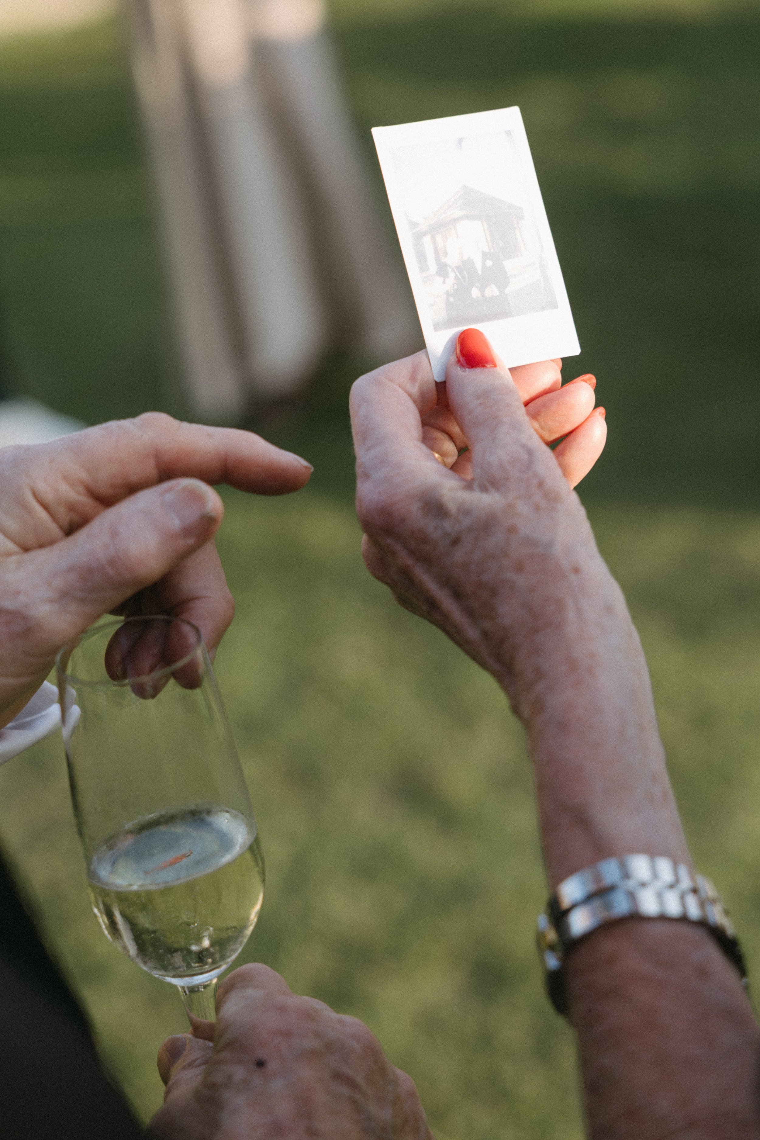 close up of guest holding polaroid waiting for it to develop