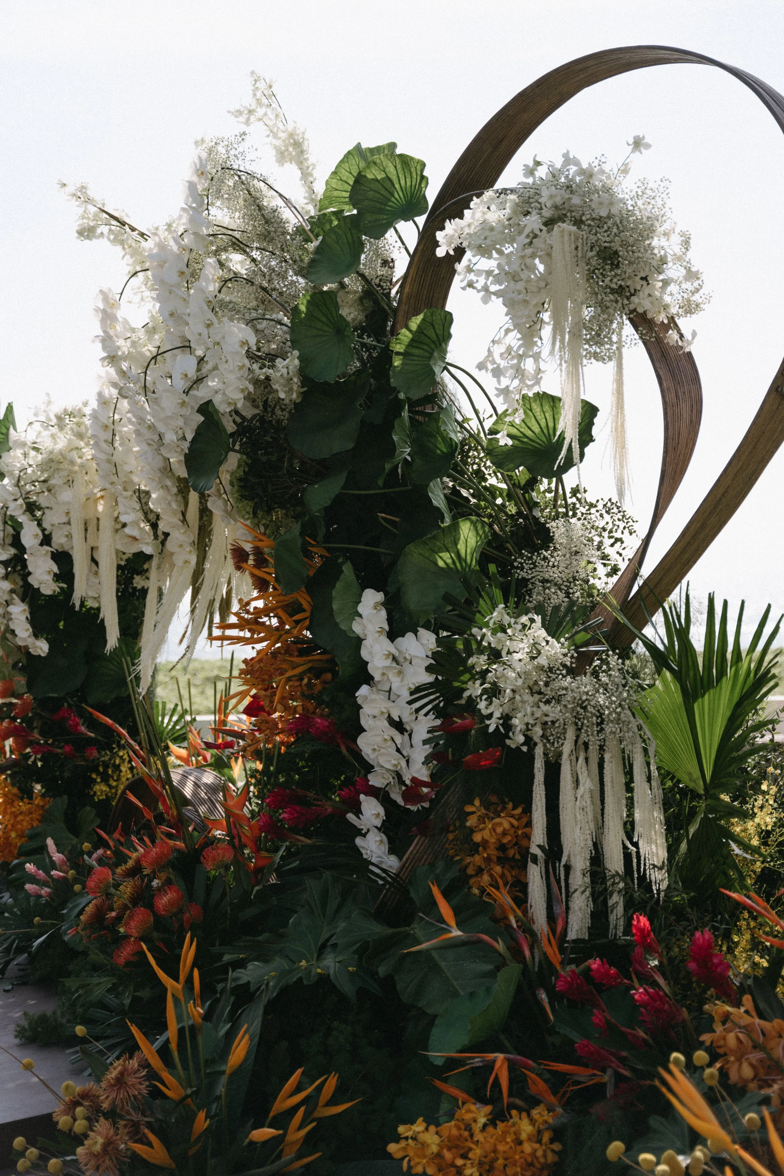 organic wedding arch structure made of florals and botanicals for destination wedding ceremony at jivana beach villas