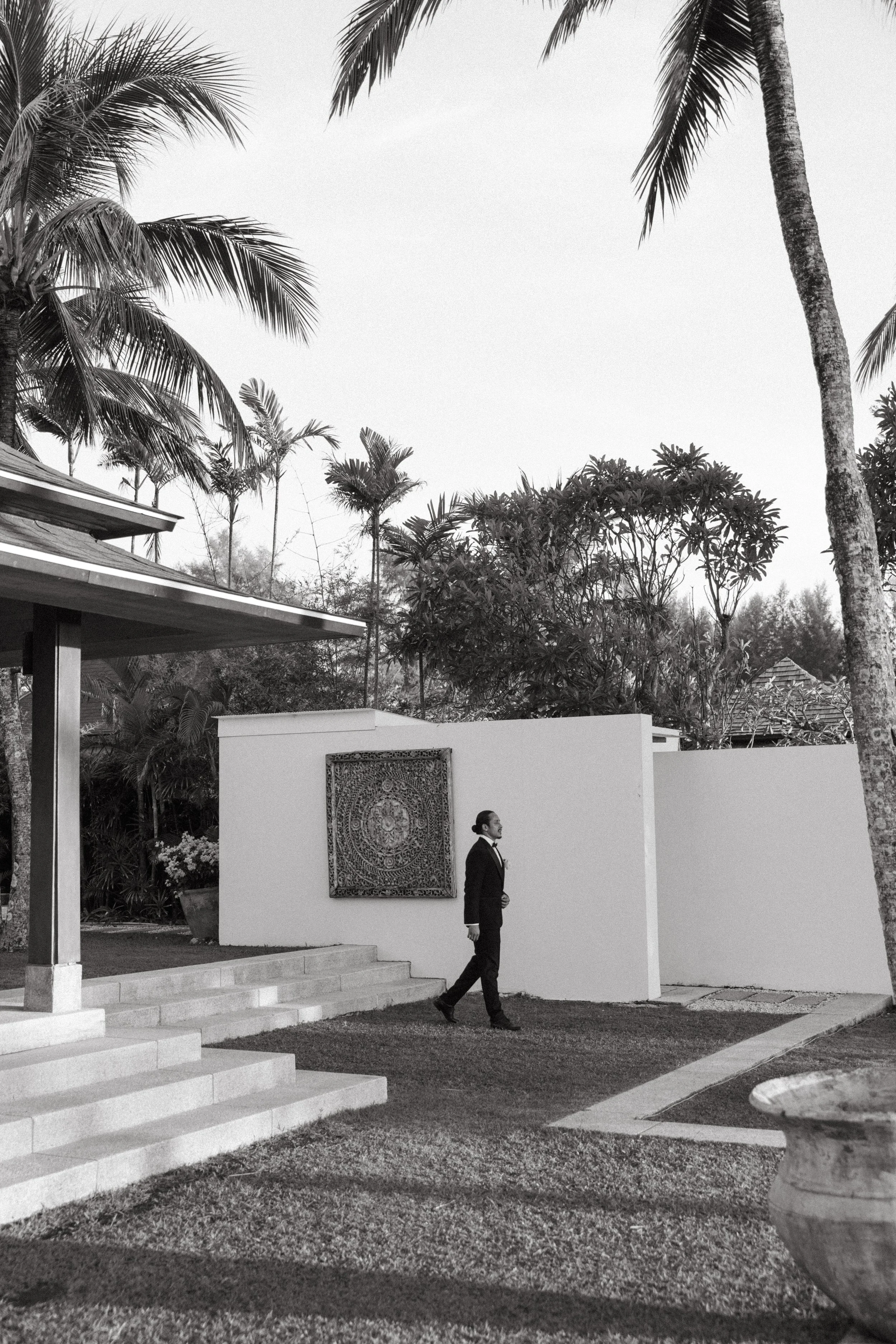 groom walking alone towards wedding ceremony 