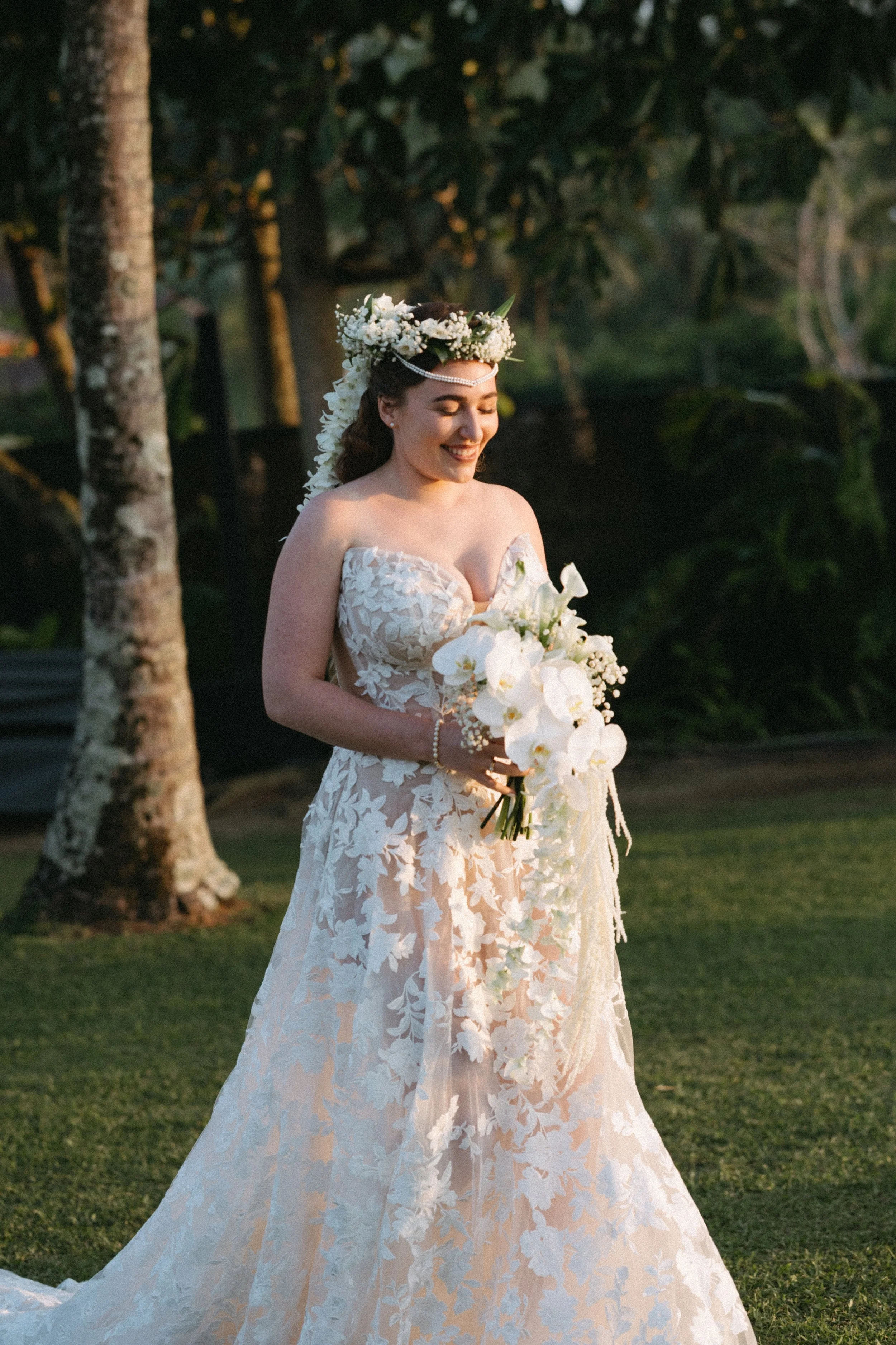 bride wearing stunning headpiece and holding orchid wedding bouquet walking down the aisle