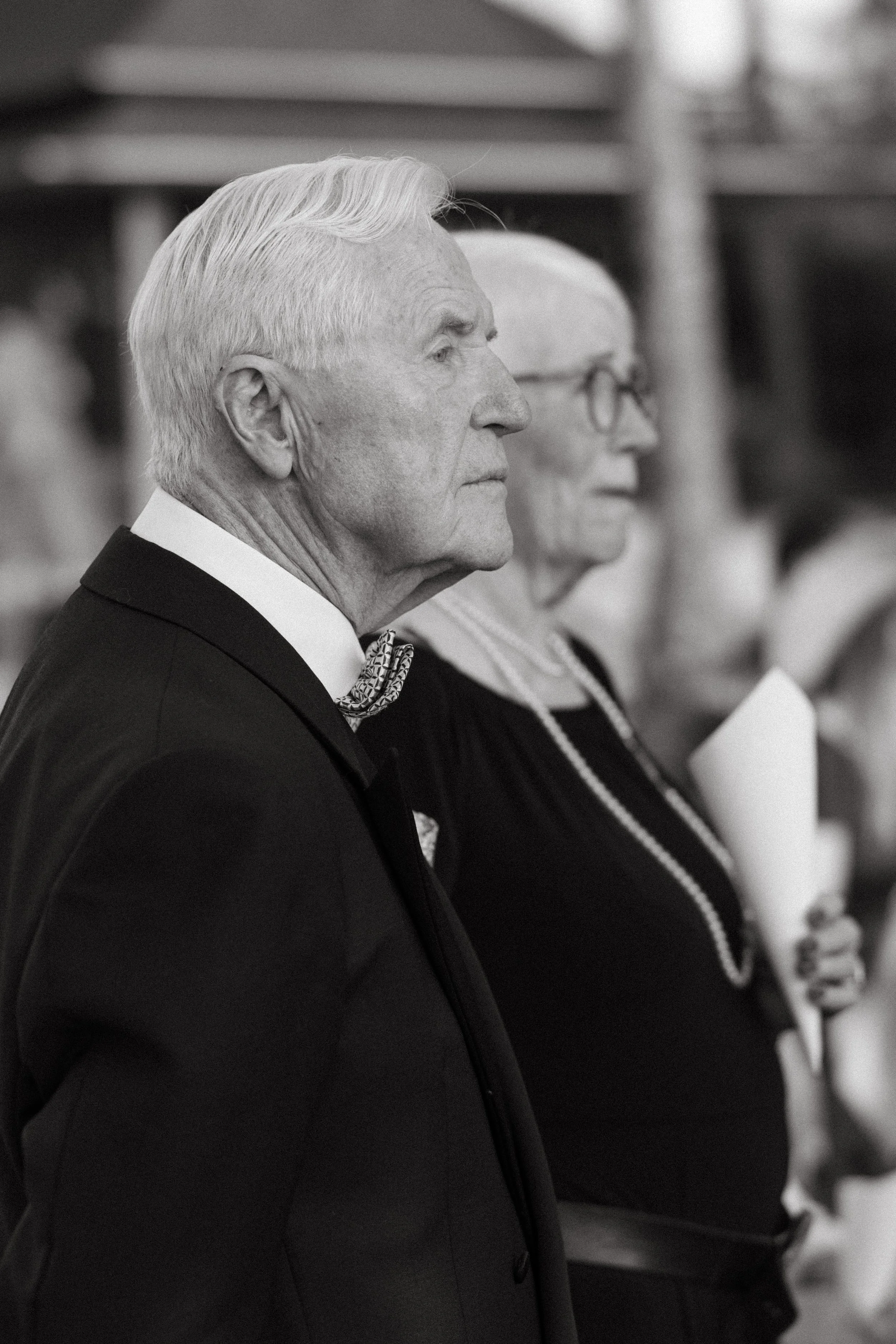 close up of bride's parents standing as she arrives for the western wedding ceremony