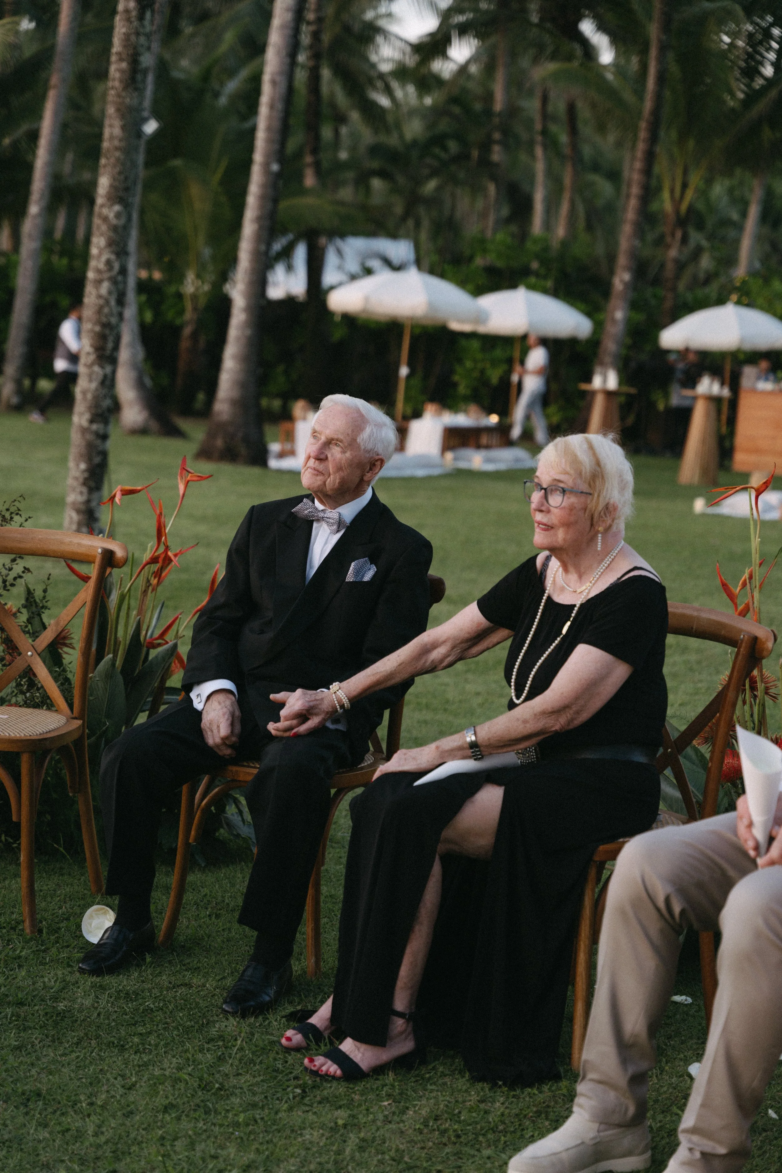 bride's parents holding hands during intimate wedding ceremony 