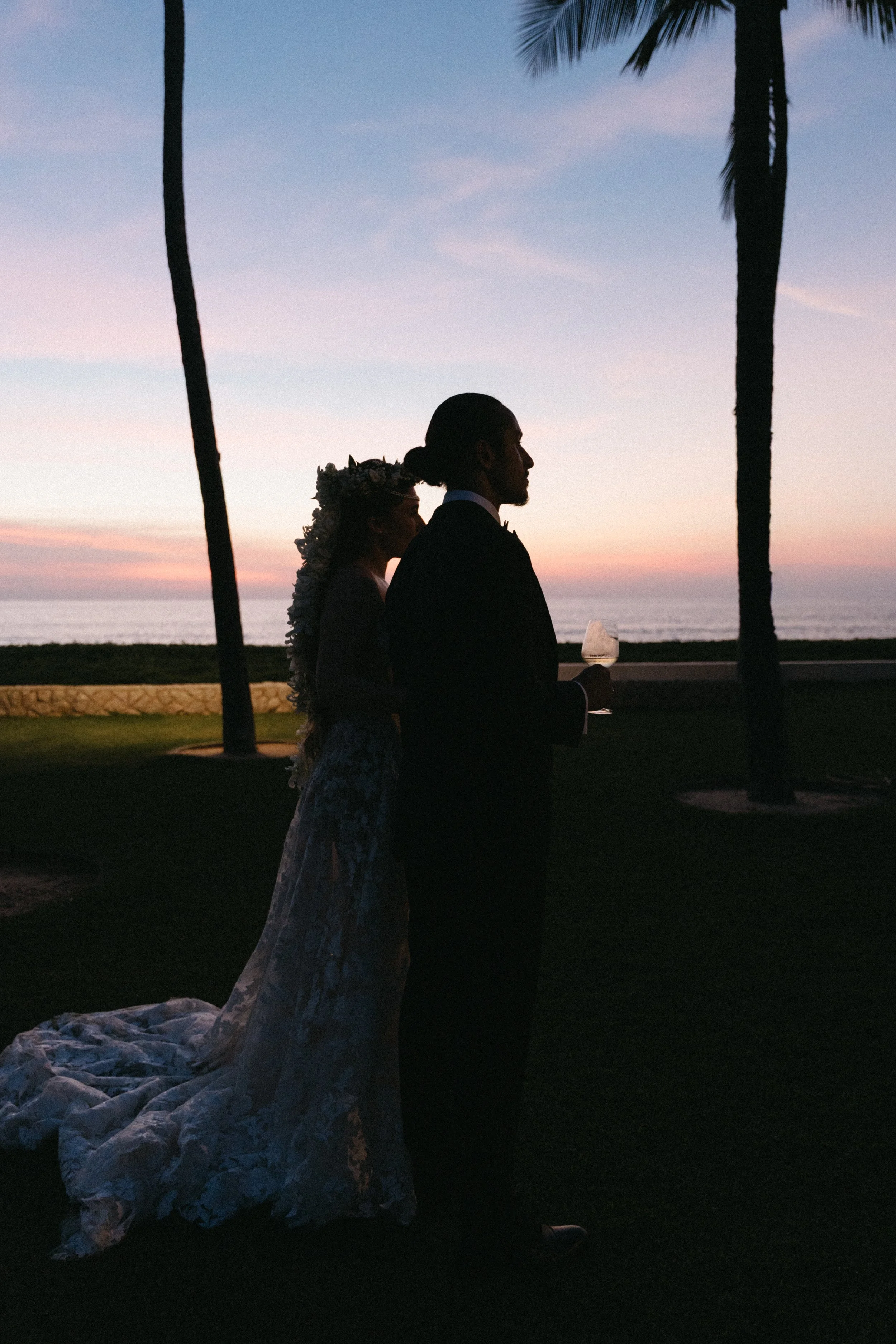 portrait of bride and groom during cocktail hour with sunset over the beach