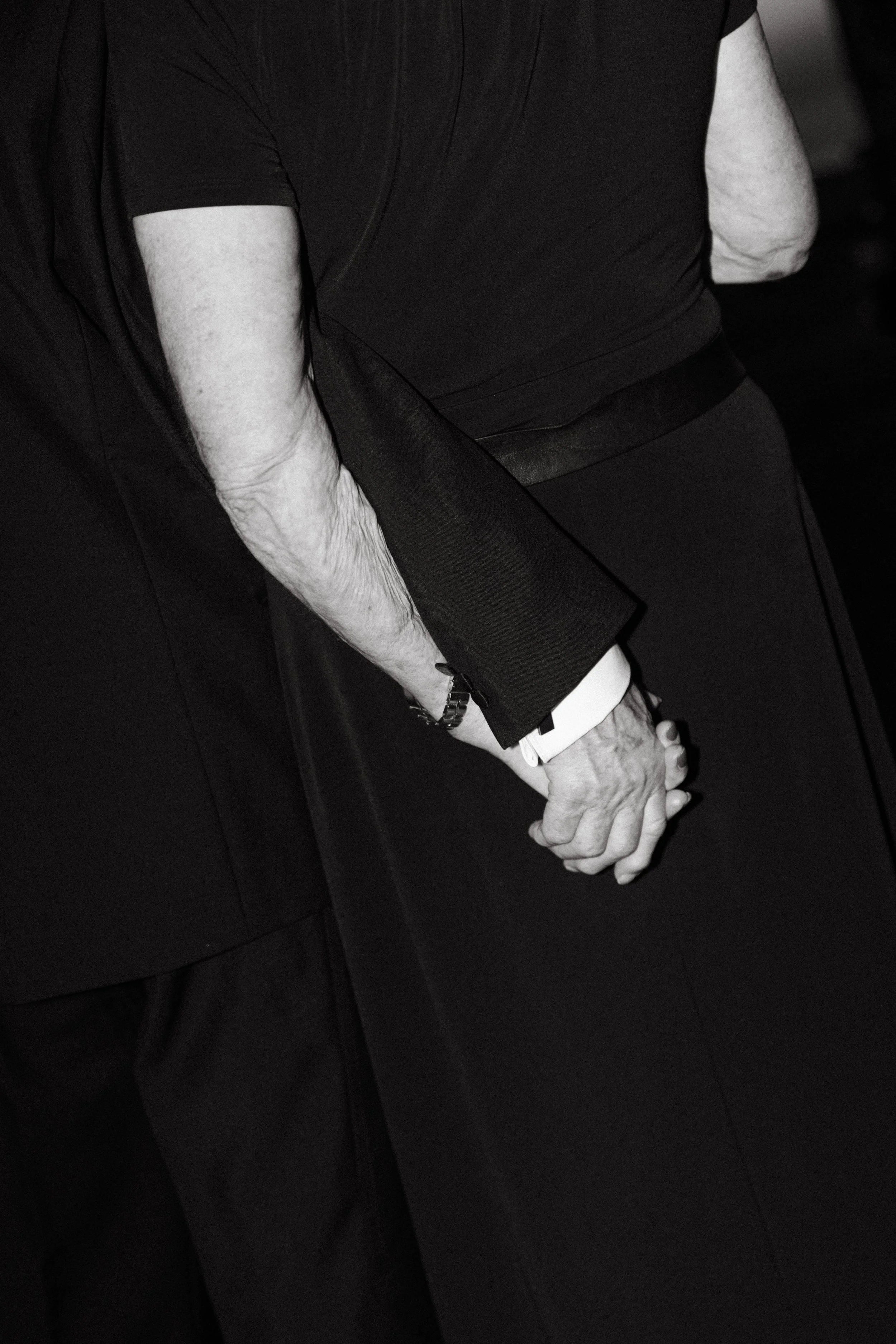 elegant close up portrait of guests holding hands during cocktail hour