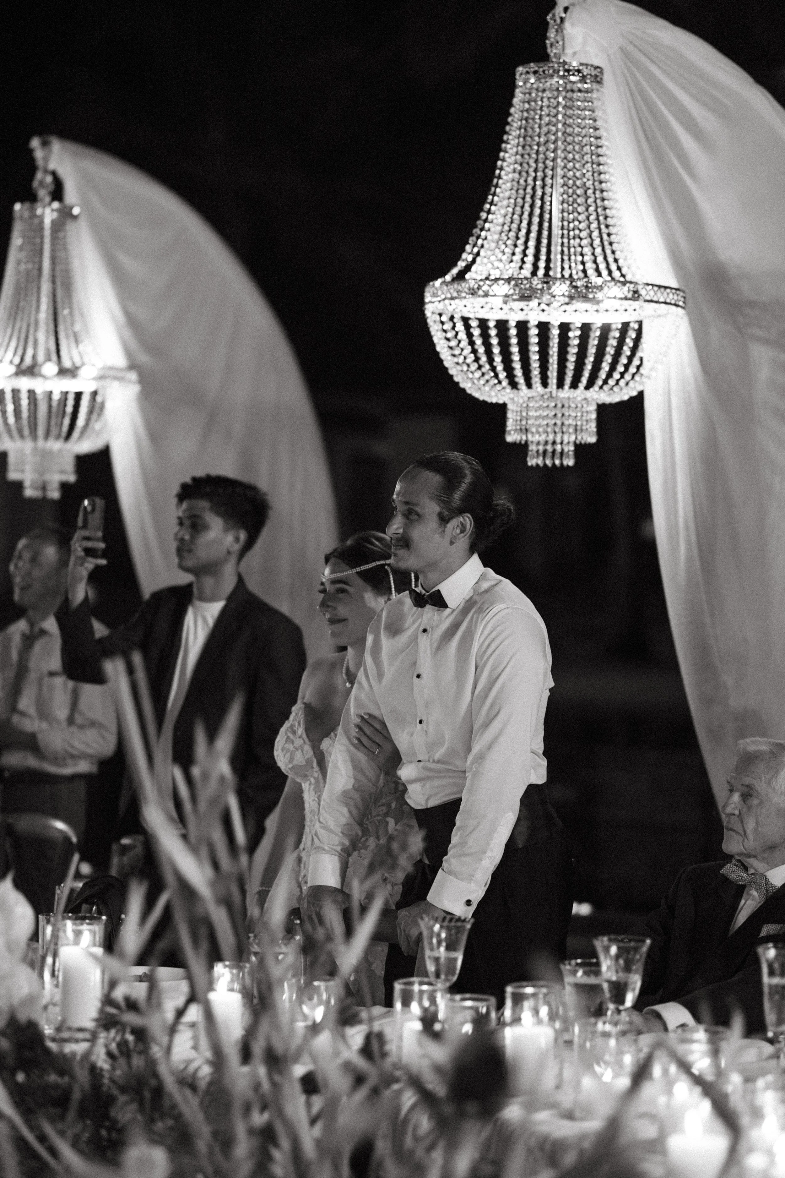 couple standing while listening to heartfelt wedding reception speeches