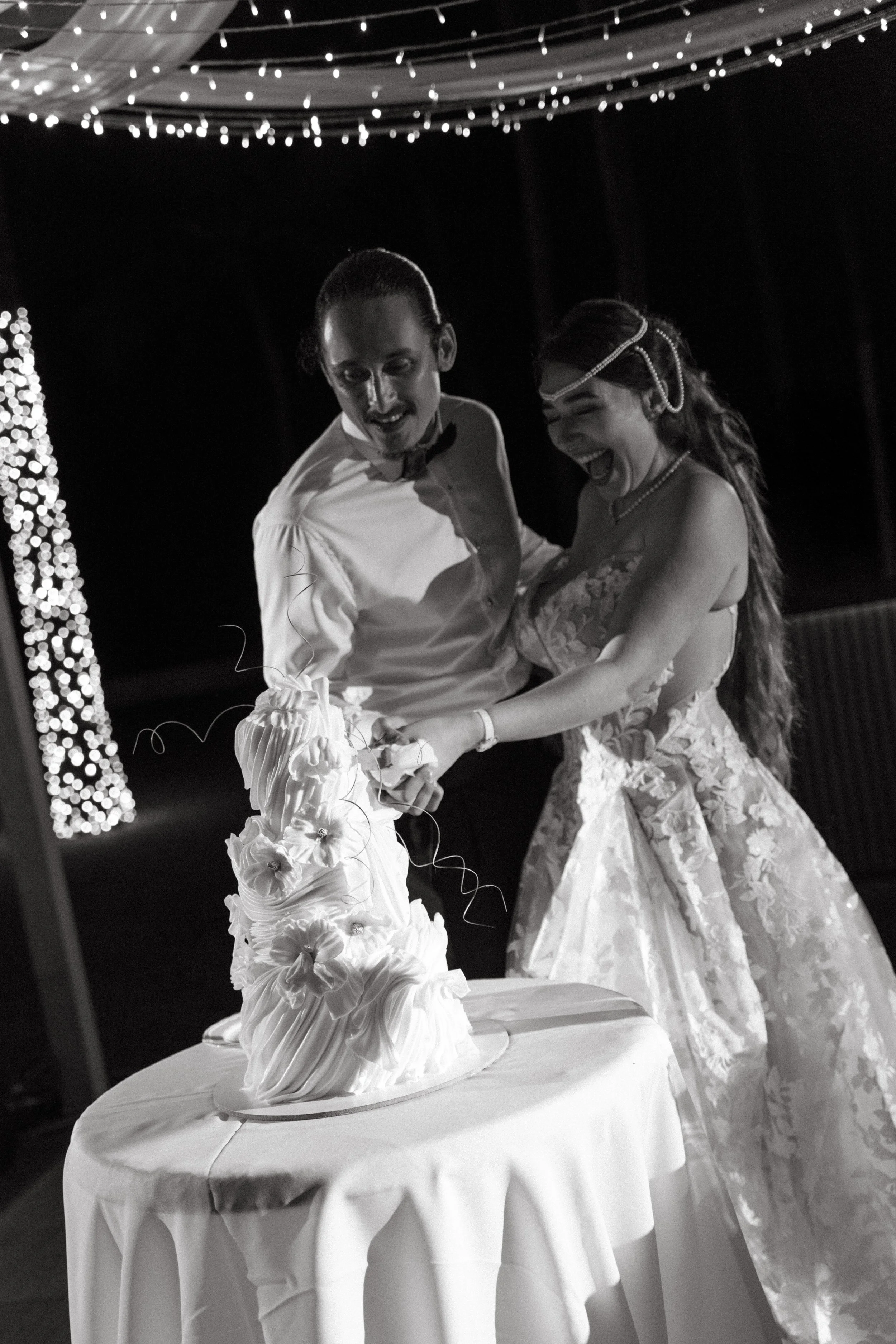 couple cutting the cake during wedding reception 
