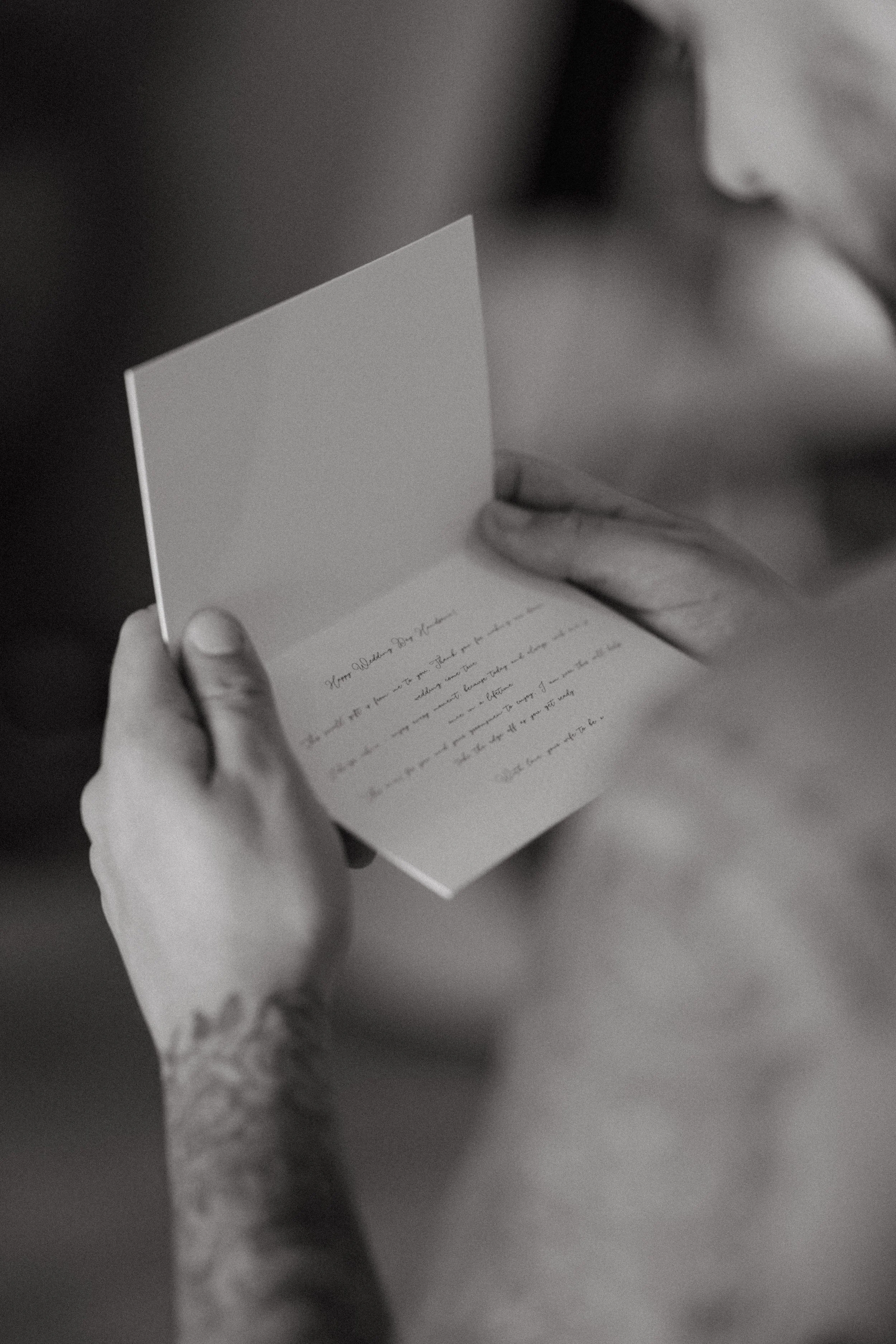 groom reading card from bride before the ceremony