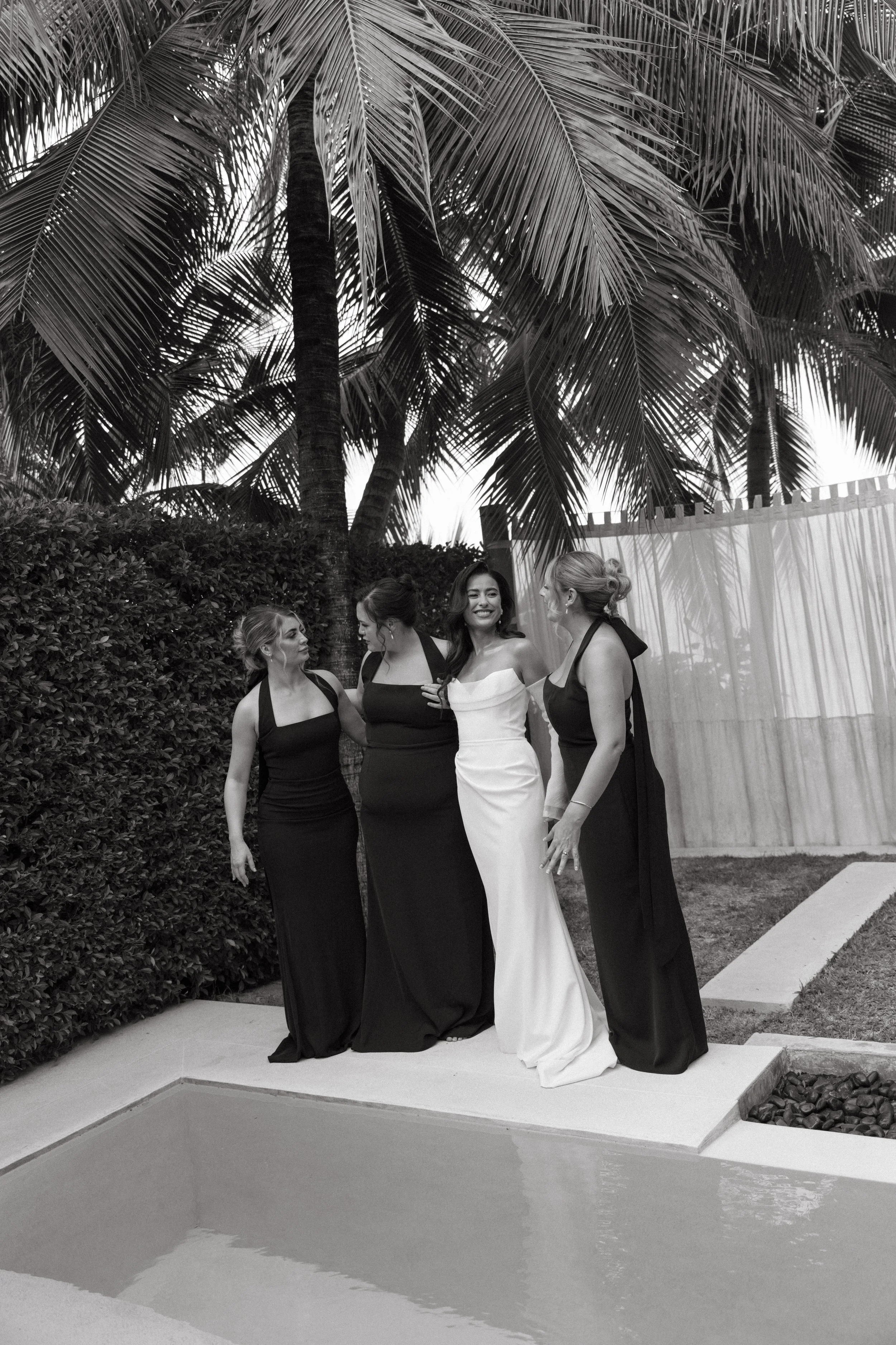 candid portrait of bride with bridesmaids next to the pool at odyssey mansion