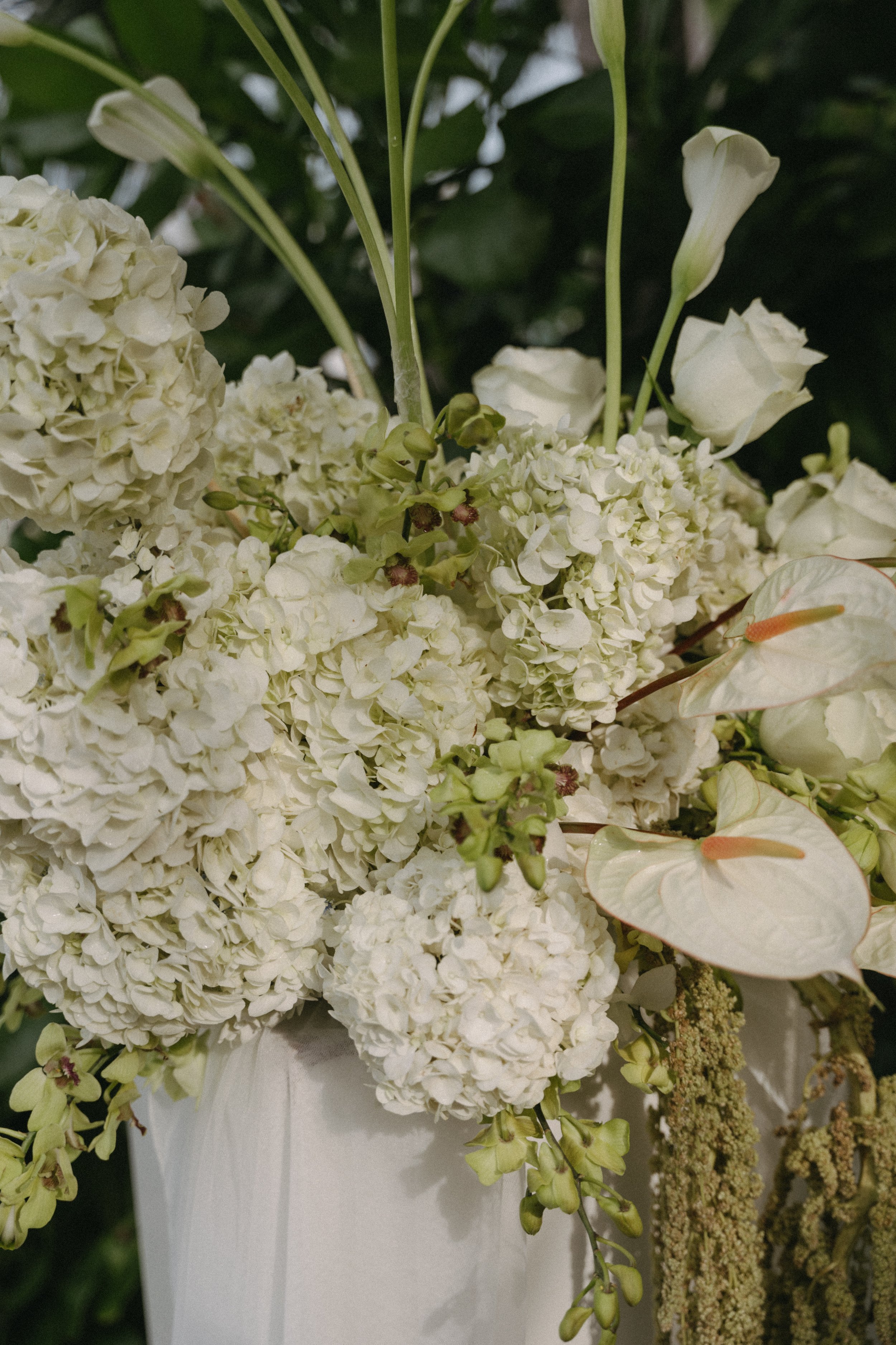 Lush white wedding florals including hydrangeas, calla lilies and anthuriums at a luxury Koh Samui destination wedding
