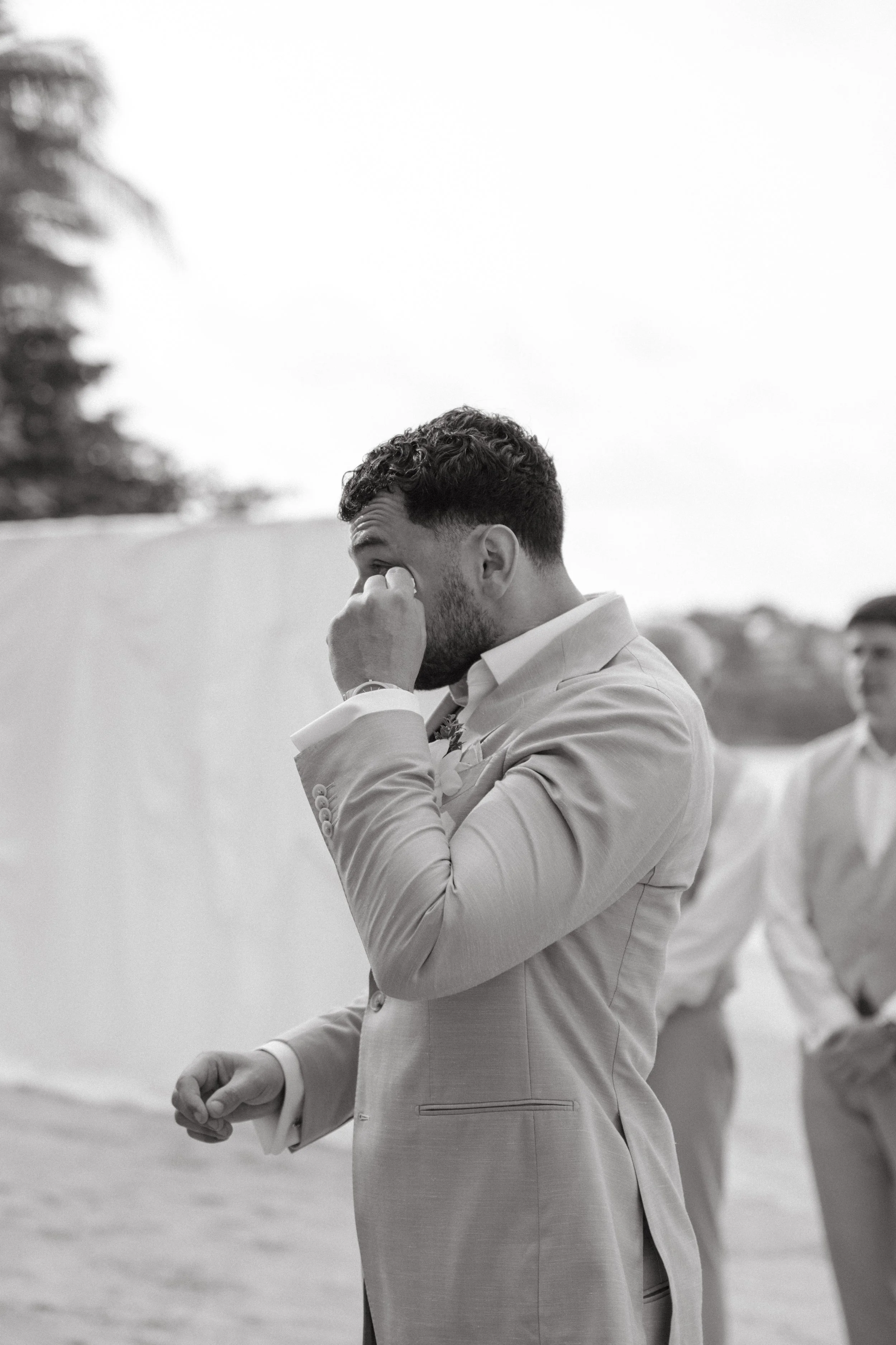groom tearing up as the ceremony officially begins on bangrak beach outside odyssey mansion