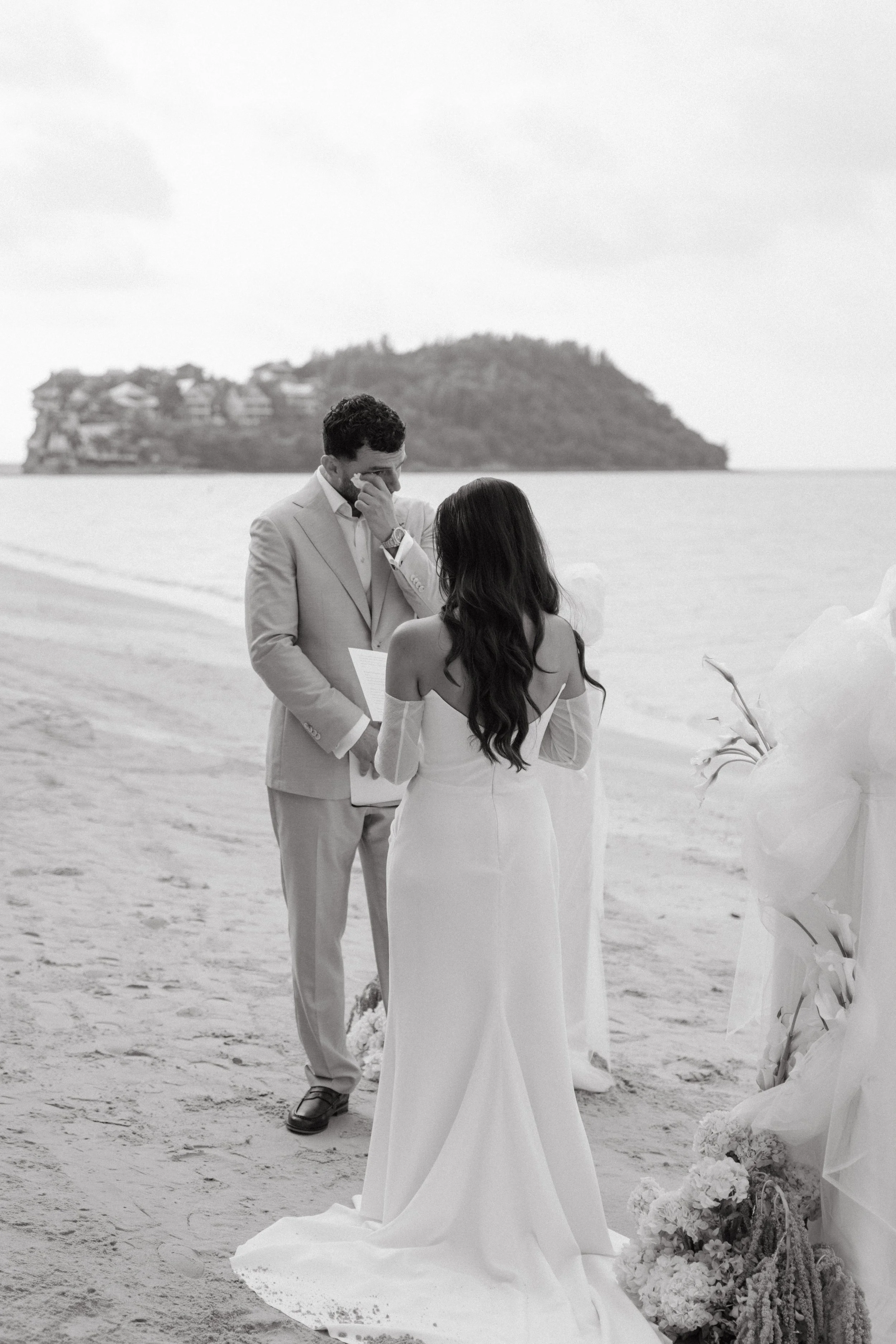 groom crying as bride reads her vows during outdoor beach wedding ceremony on bangrak beach