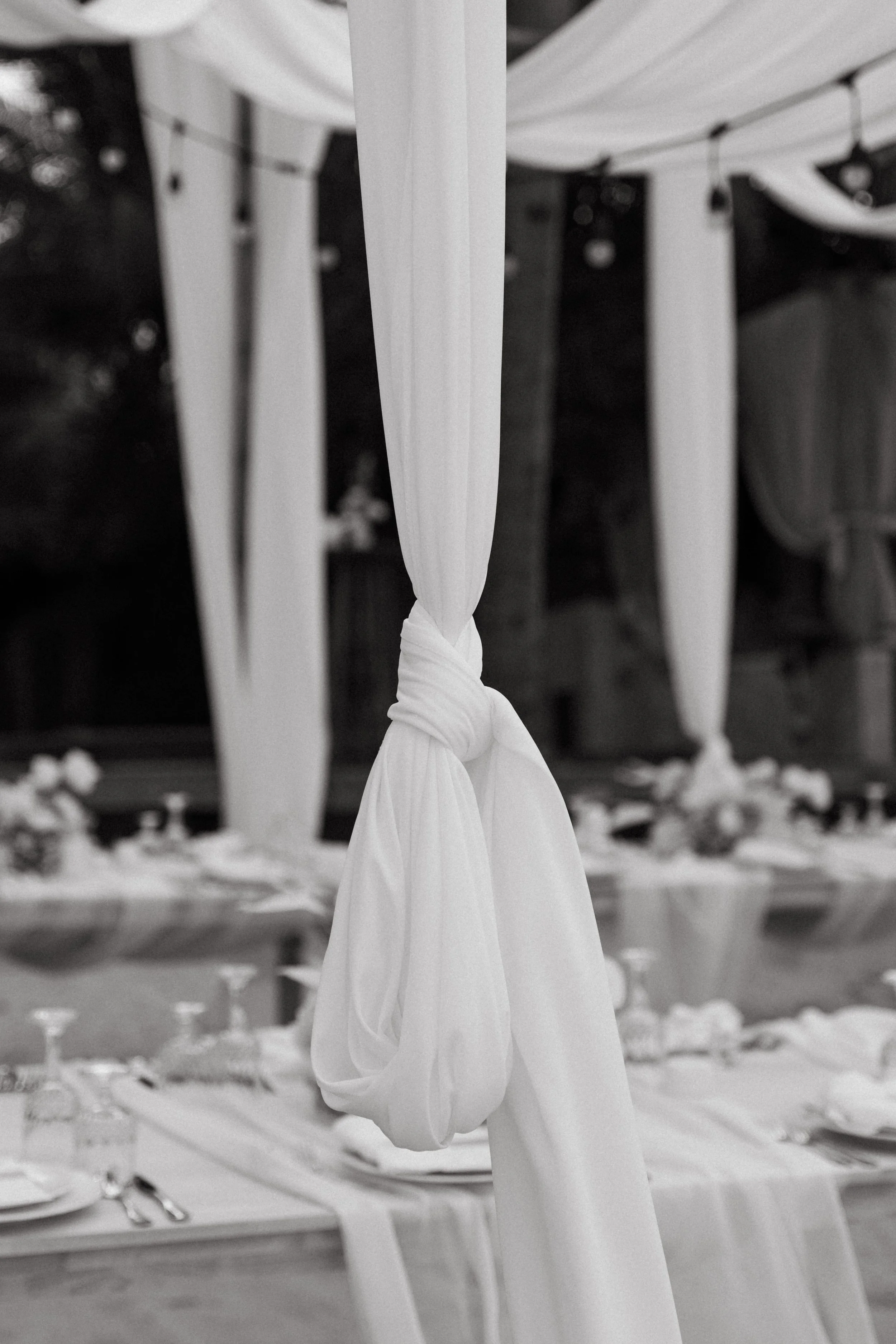Elegant white draping and fairy lights at a beachfront wedding reception at Odyssey Mansion, Koh Samui