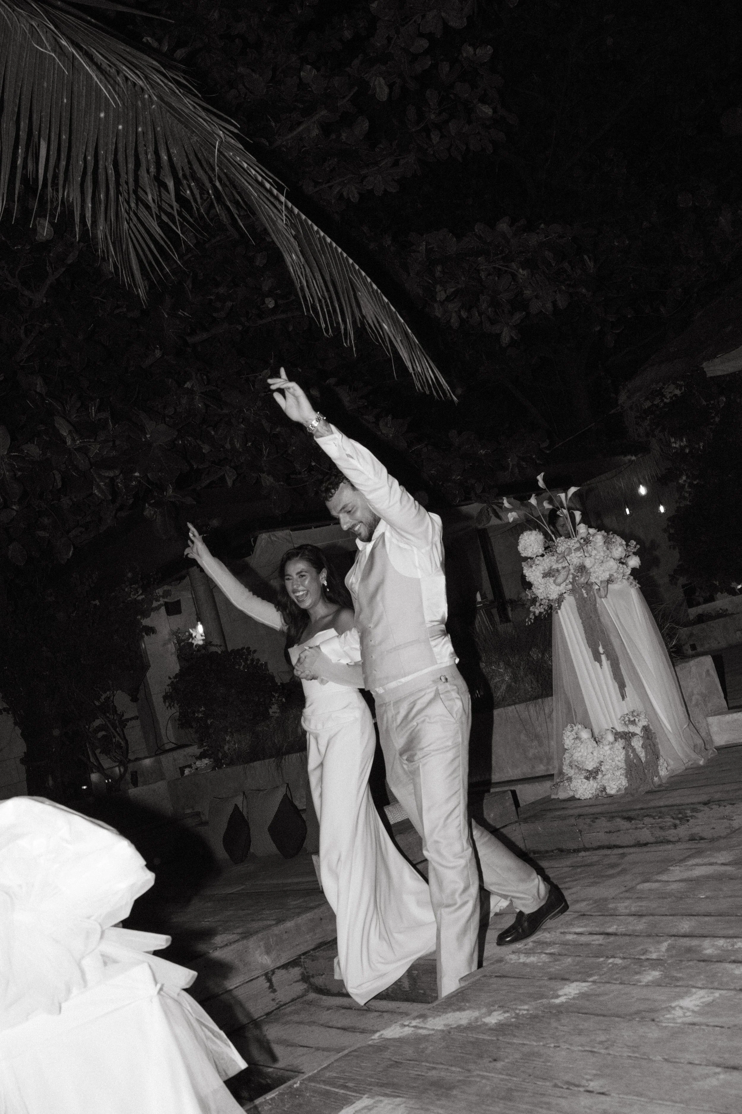 Bride and groom arriving for the outdoor evening wedding reception at Odyssey Mansion, Koh Samui