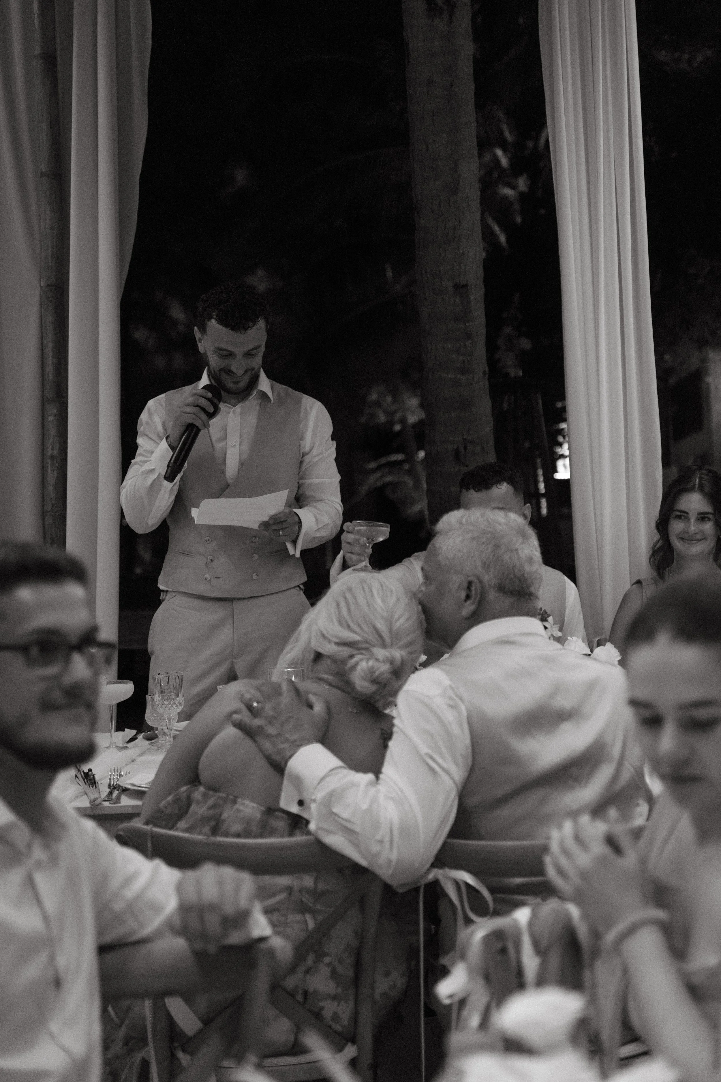 Groom reading speech during evening reception celebrations at Bangrak Beach, Koh Samui