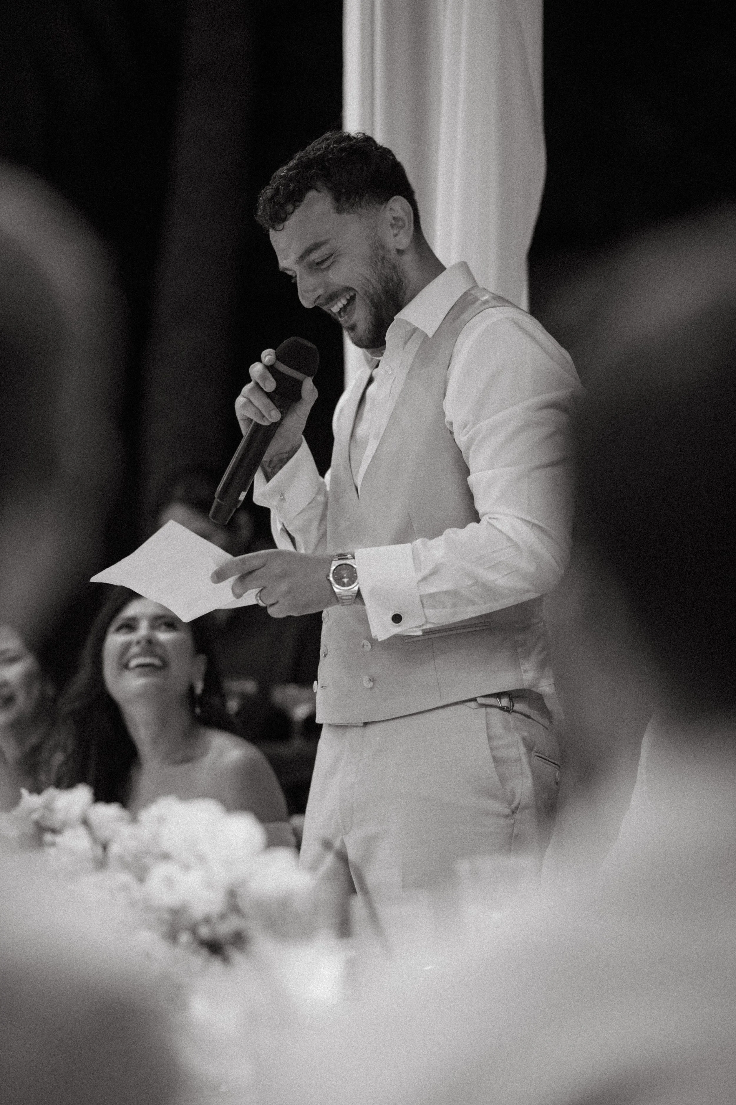 Groom reading speech during evening celebrations at Bangrak Beach, Koh Samui